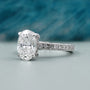 White gold oval cut diamond ring with pavé band design
