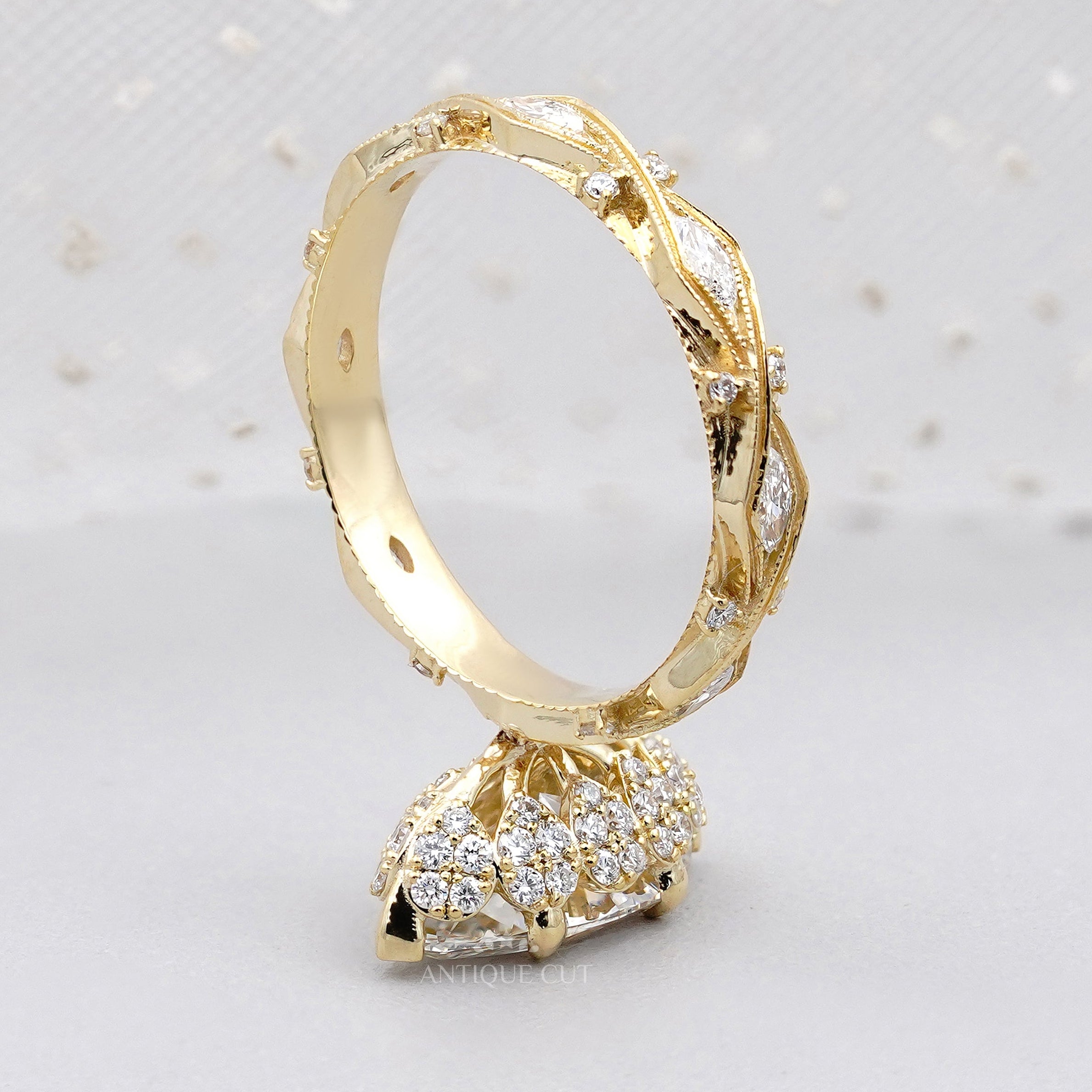 Yellow gold marquise diamond engagement ring with side stones
