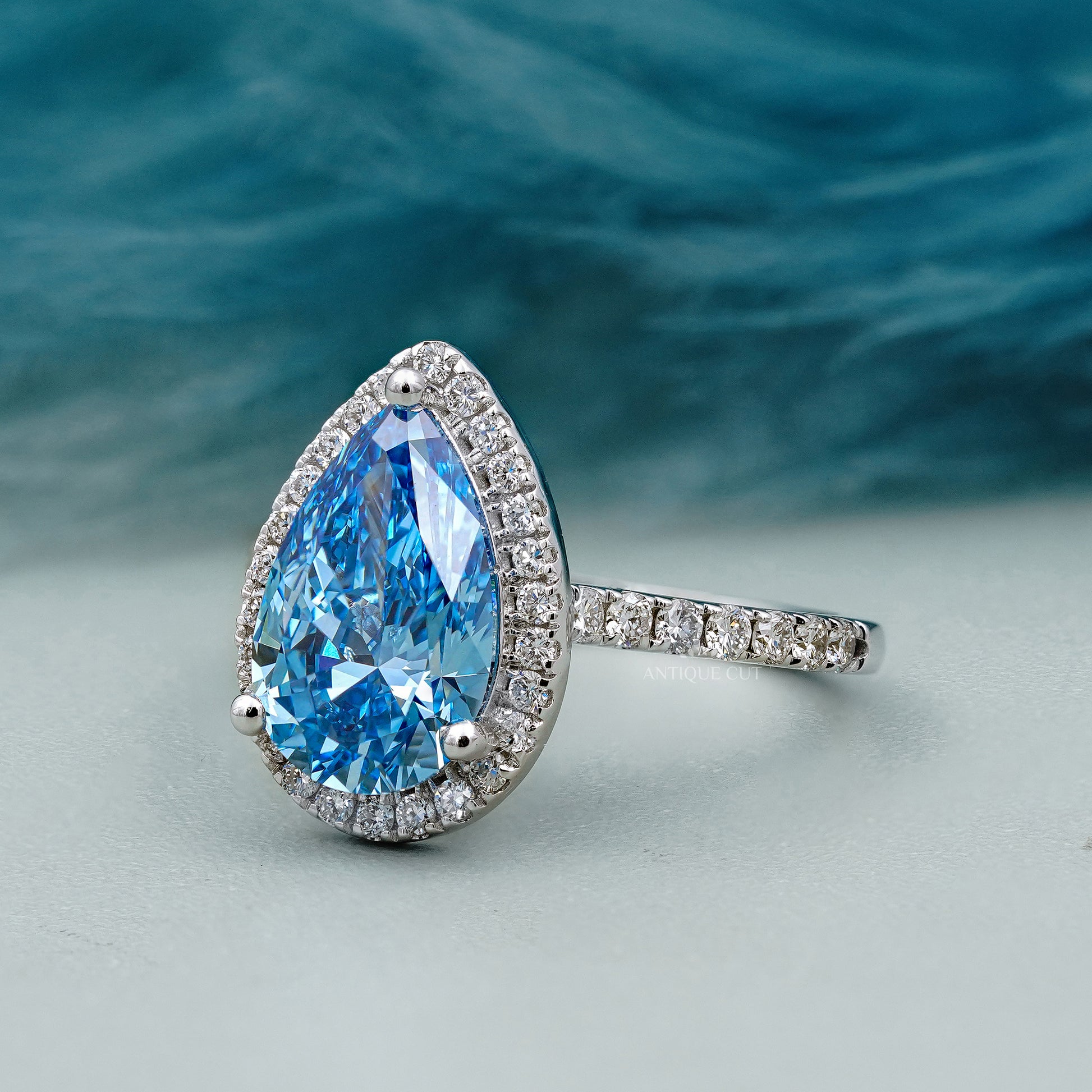 Lab grown blue diamond pear ring white gold halo
