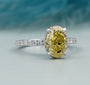 Oval engagement ring with hidden halo and pavé band
