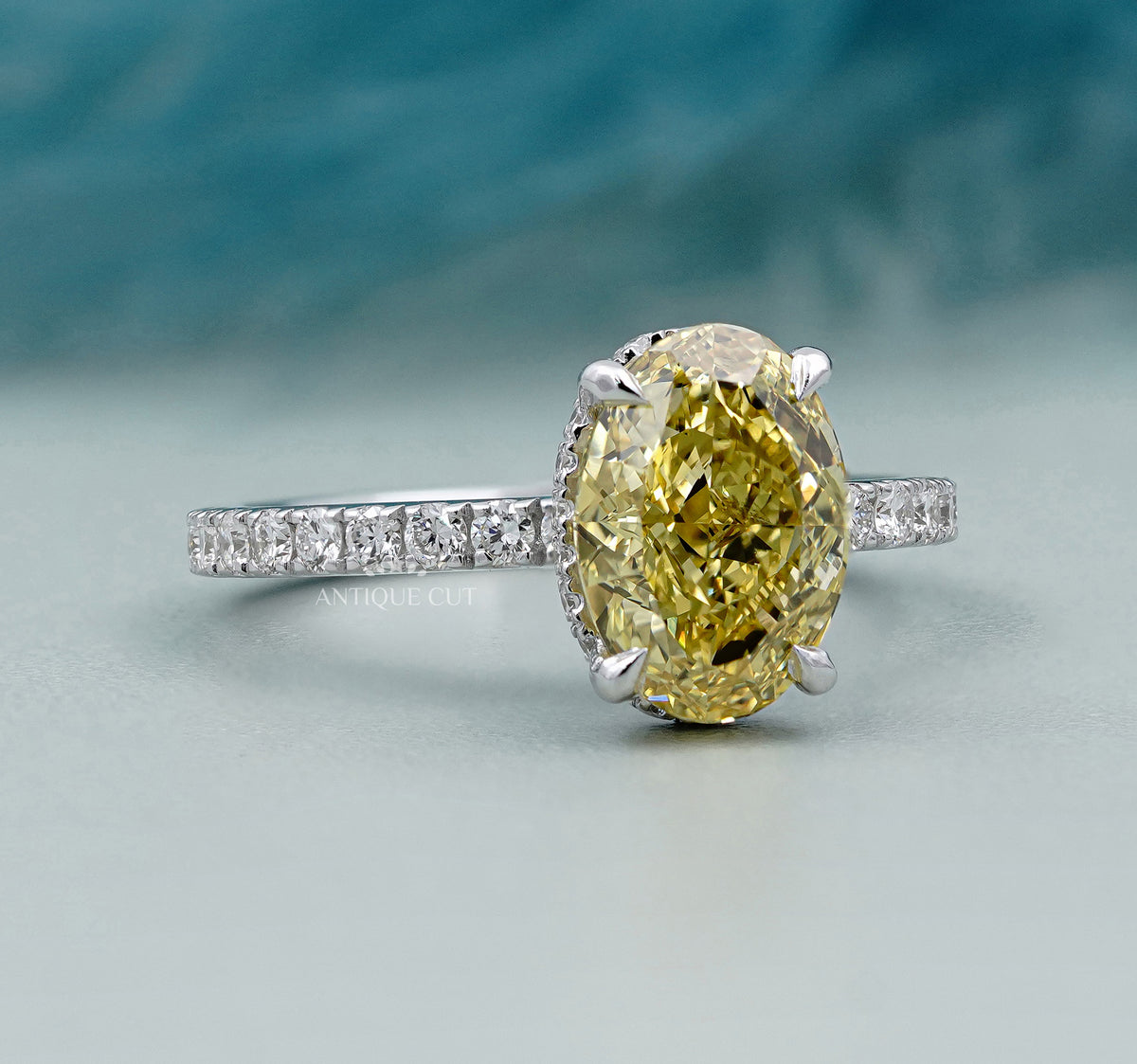 Oval engagement ring with hidden halo and pavé band