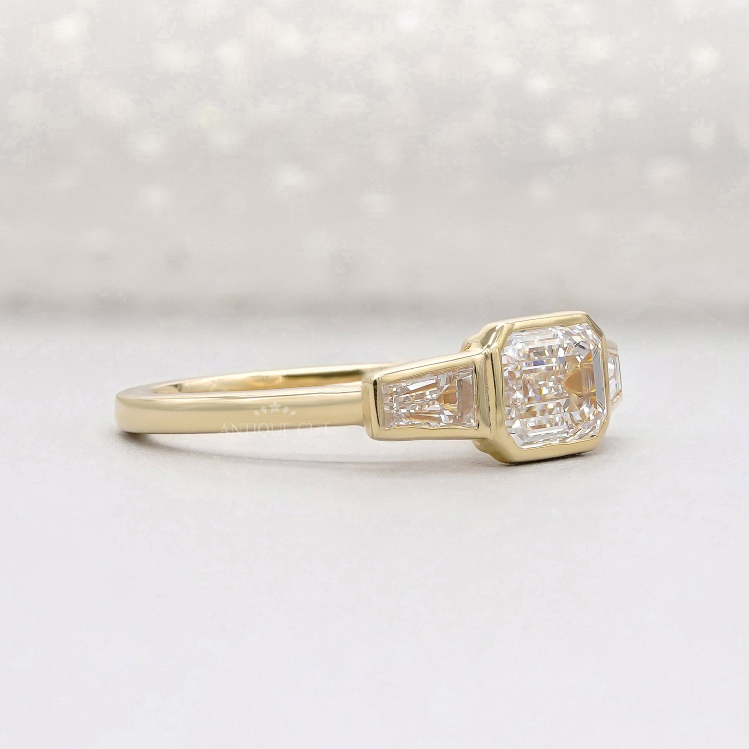 elegant emerald three stone engagement ring close-up