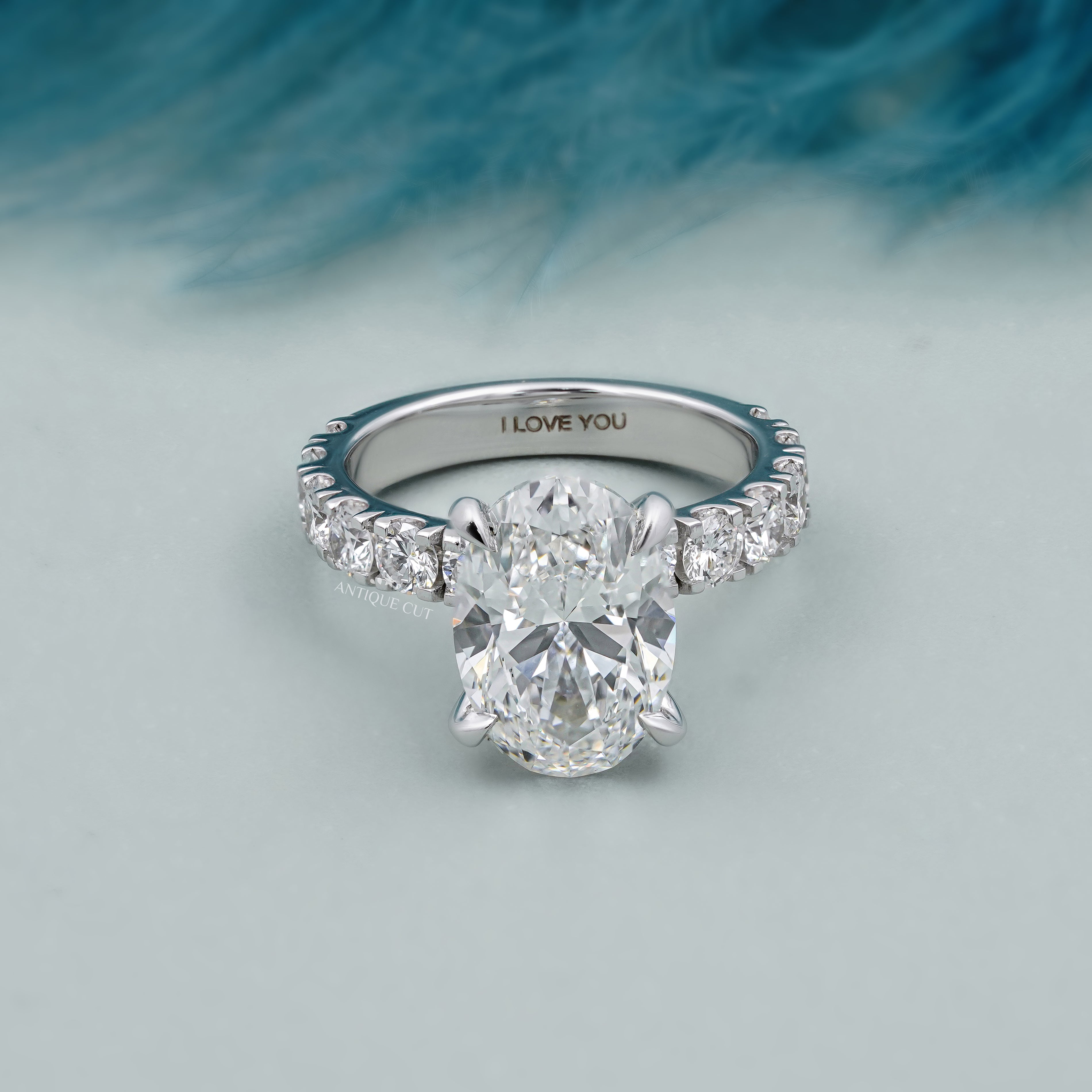Oval diamond bridal ring with diamond accented band