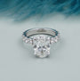 Oval diamond bridal ring with diamond accented band