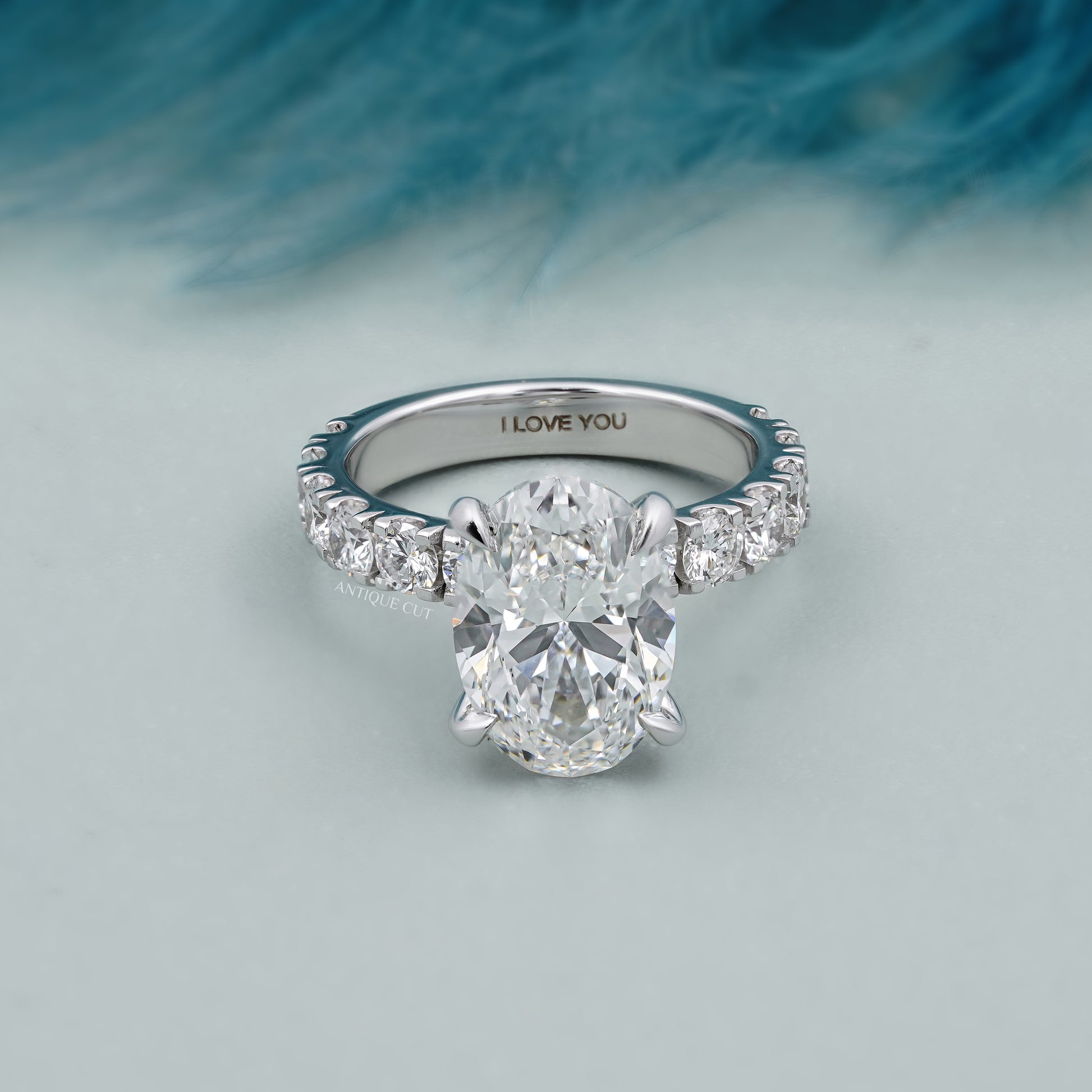 Oval diamond bridal ring with diamond accented band