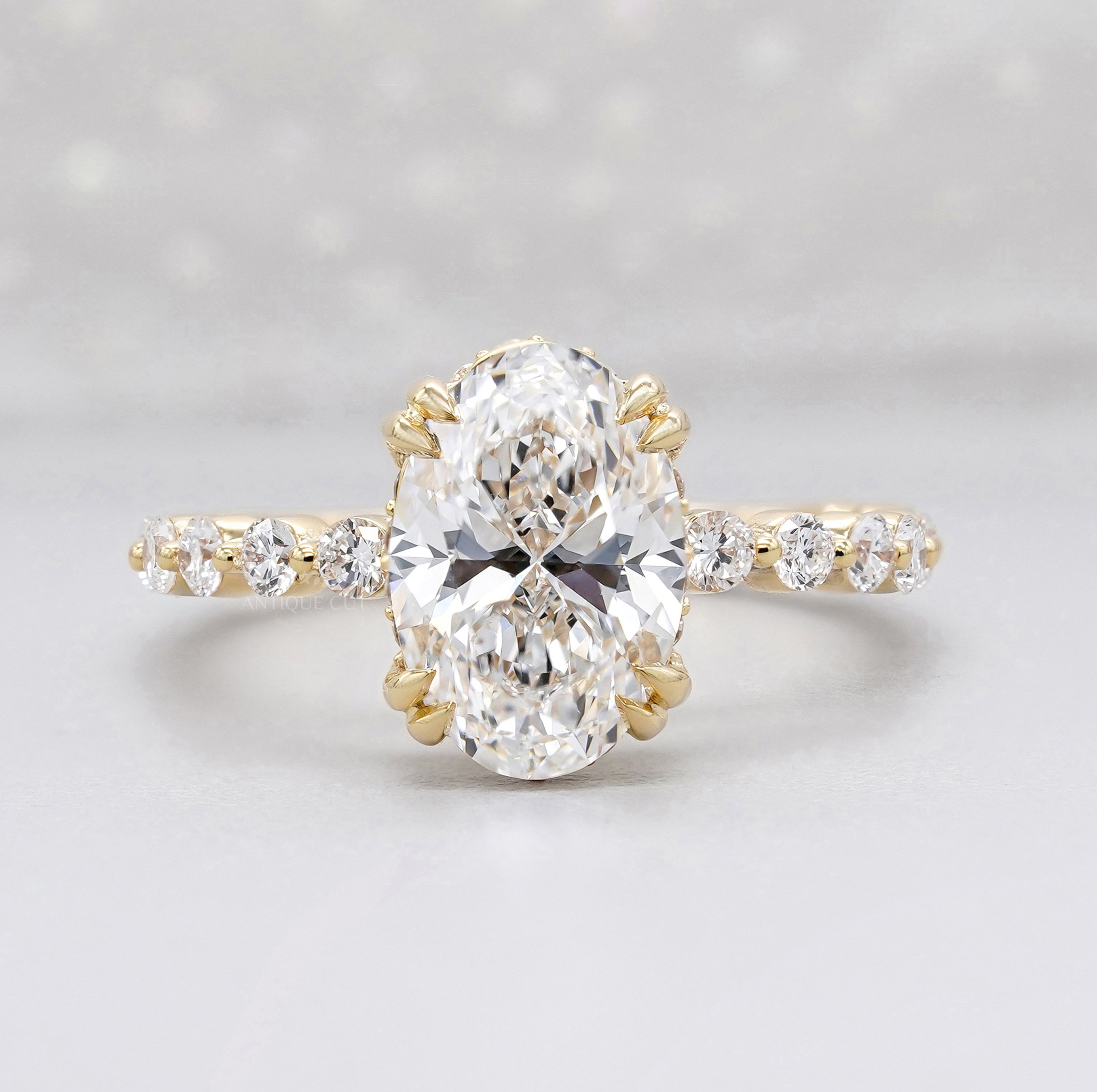 Hidden halo oval engagement ring in yellow gold