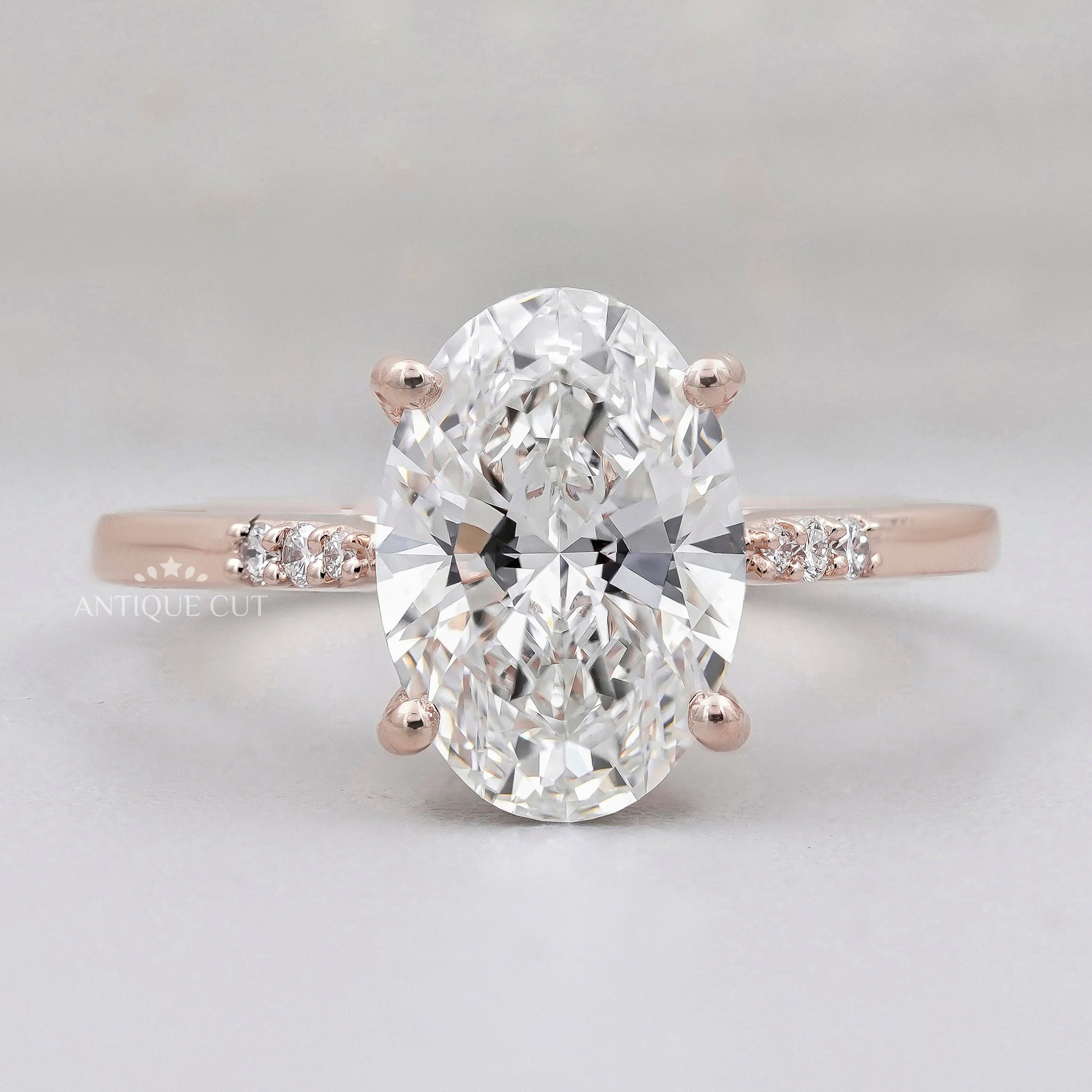 Oval diamond engagement ring with pavé band in rose gold