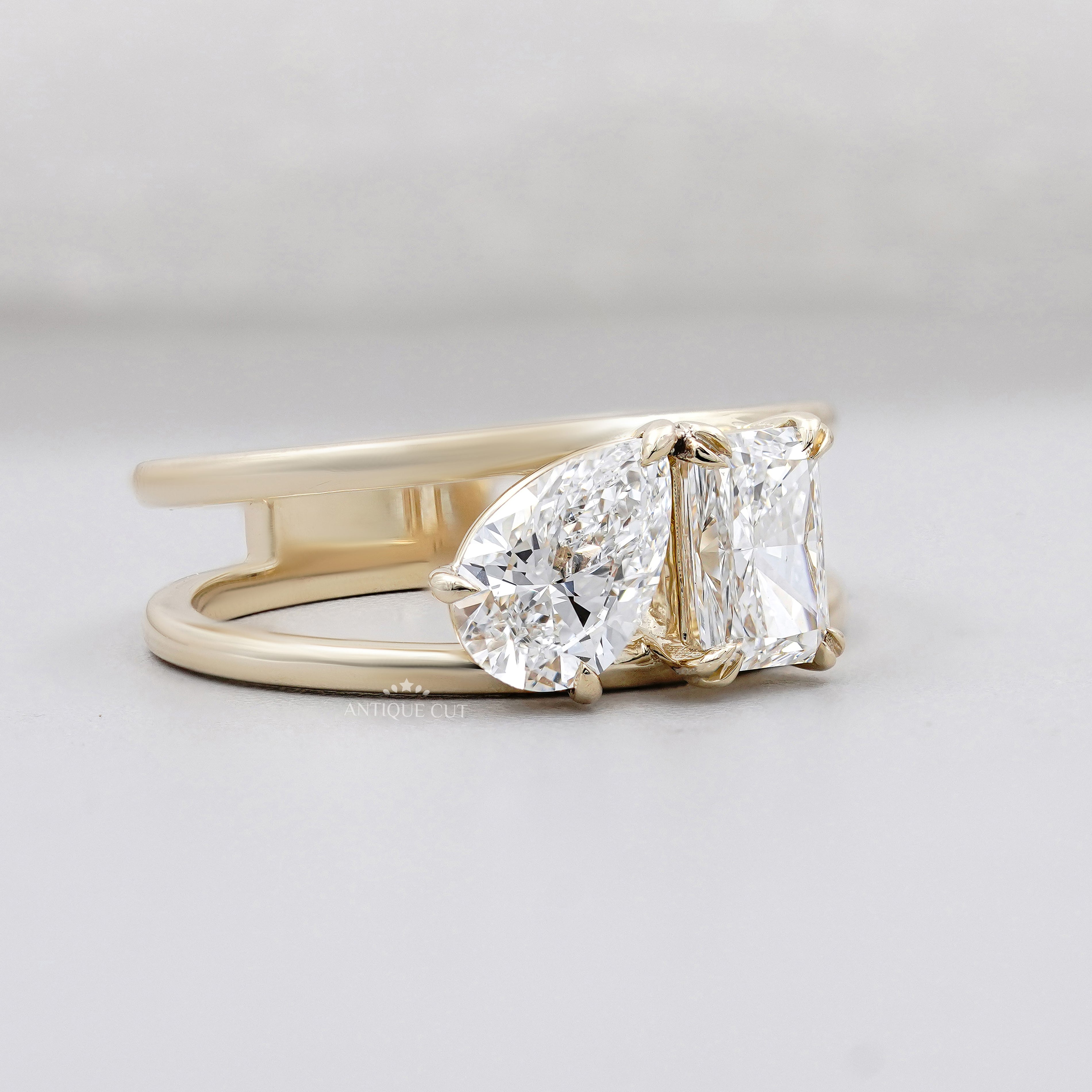 Toi et moi diamond ring with pear shaped and elongated radiant center stones