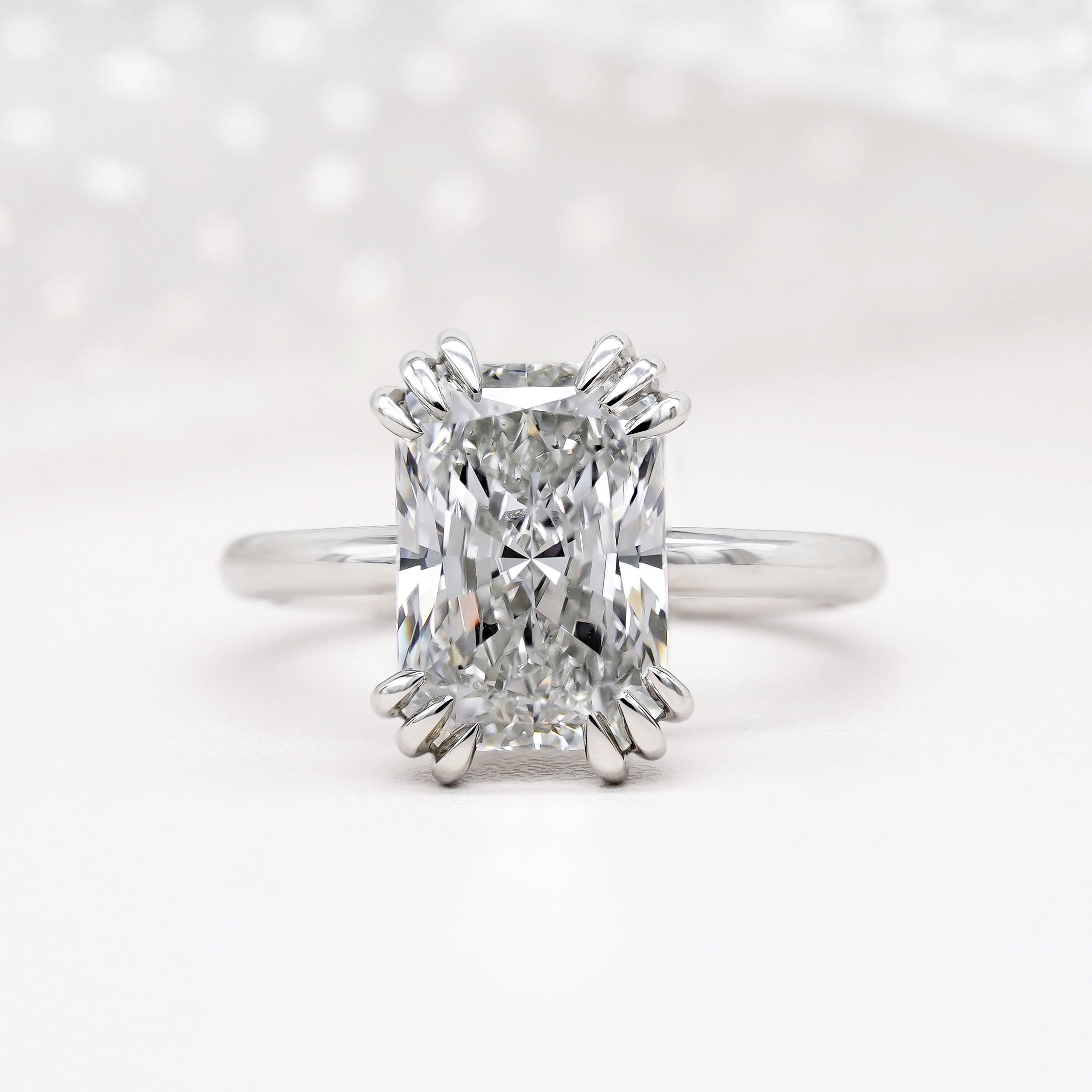Solitaire radiant cut engagement ring in white gold
