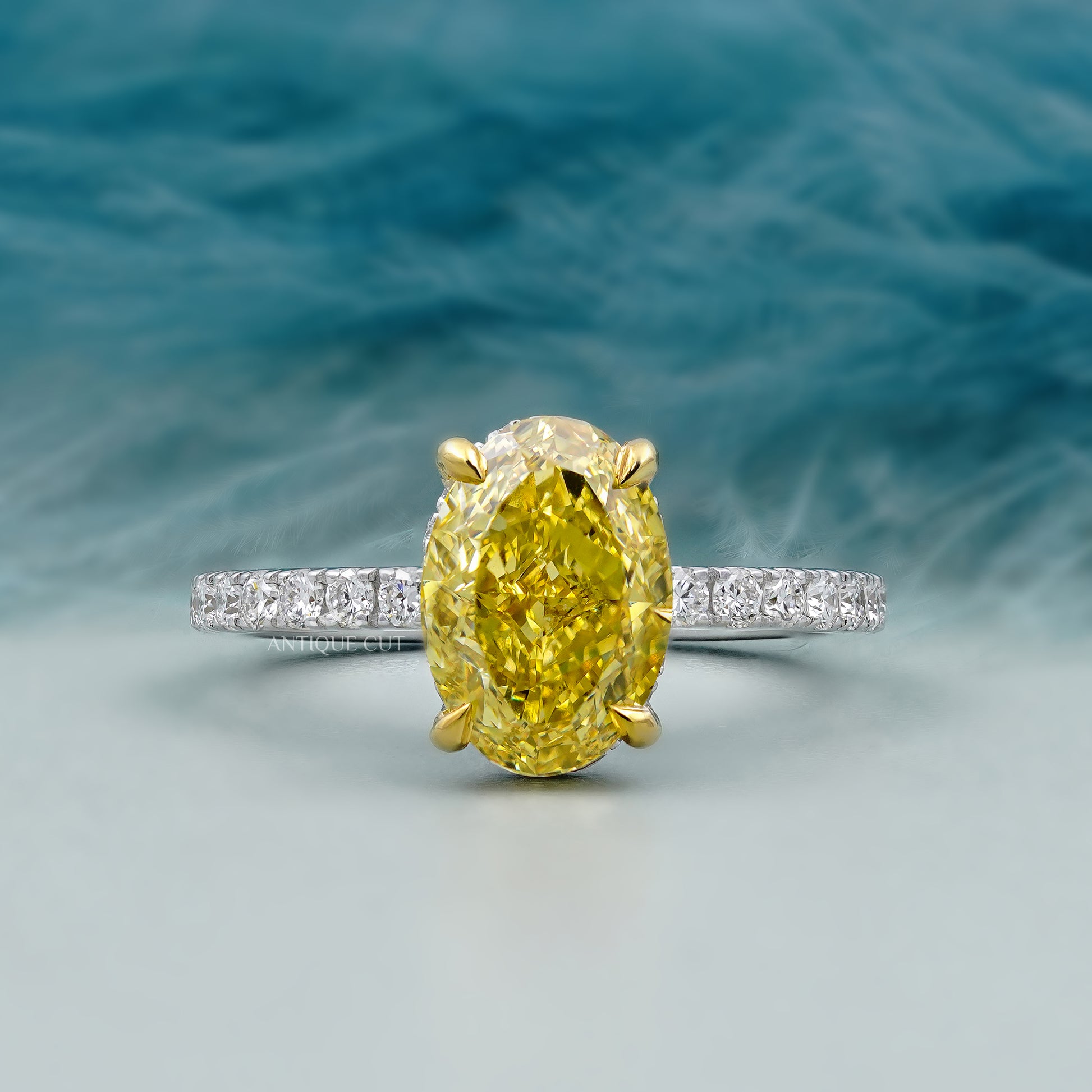 Ring with a yellow gemstone and diamond-studded band