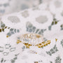 Emerald cut diamond eternity ring on lace.
