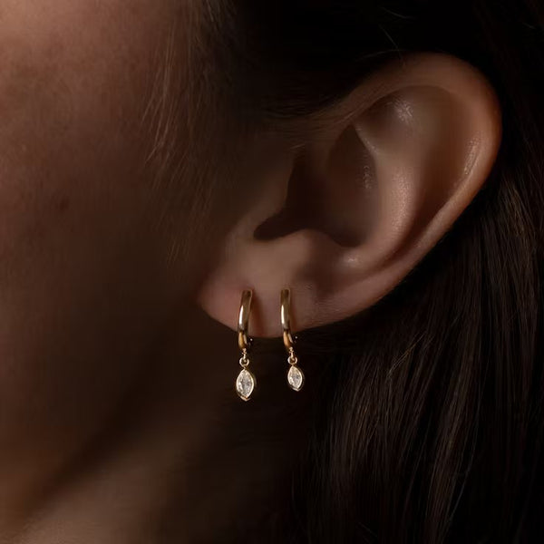 Marquise huggie hoop earrings on model in small and large sizes