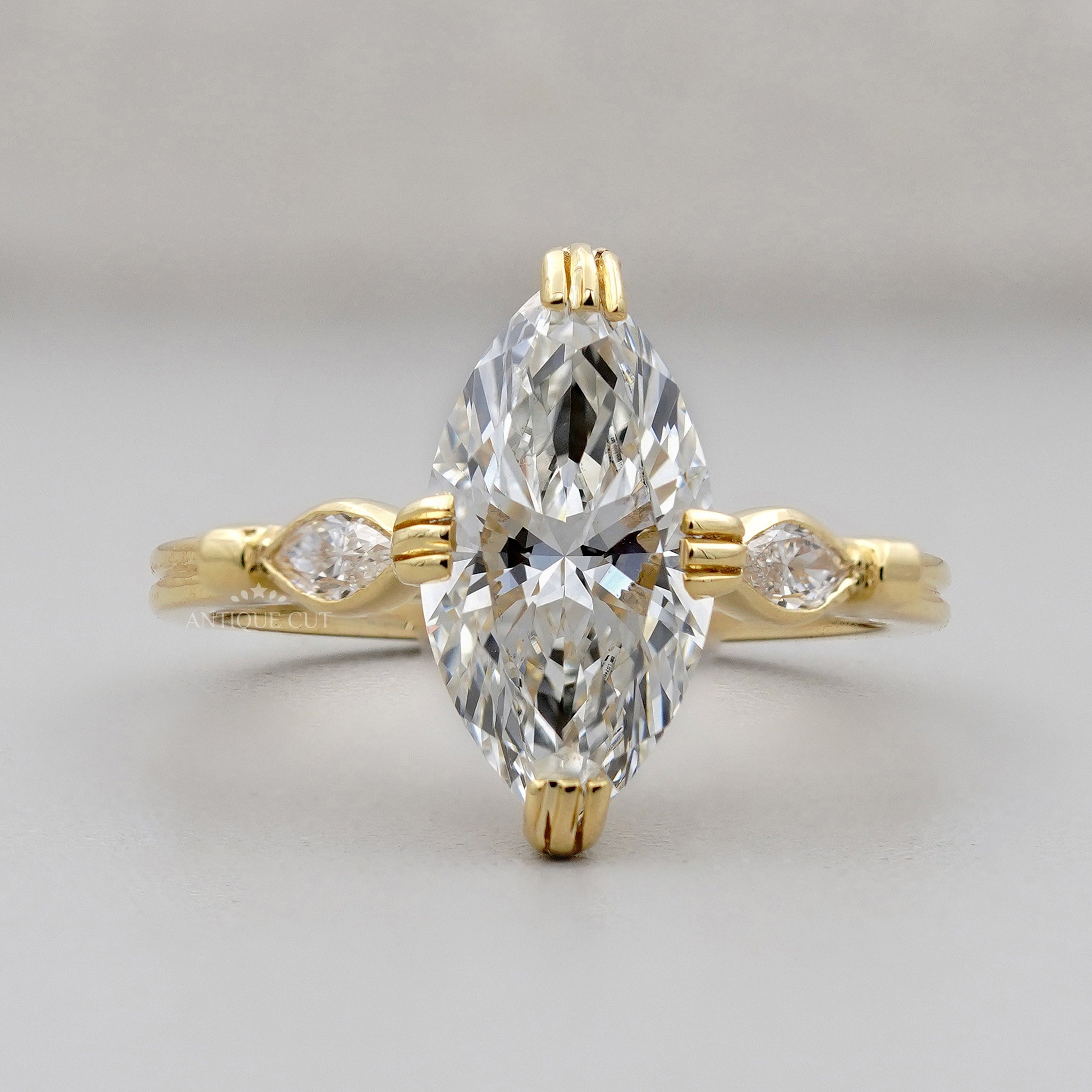 Three stone marquise engagement ring with hidden halo