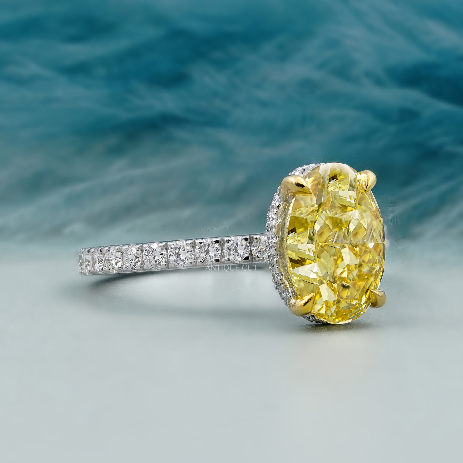 Ring with a large yellow gemstone and smaller diamonds on a blurred natural background