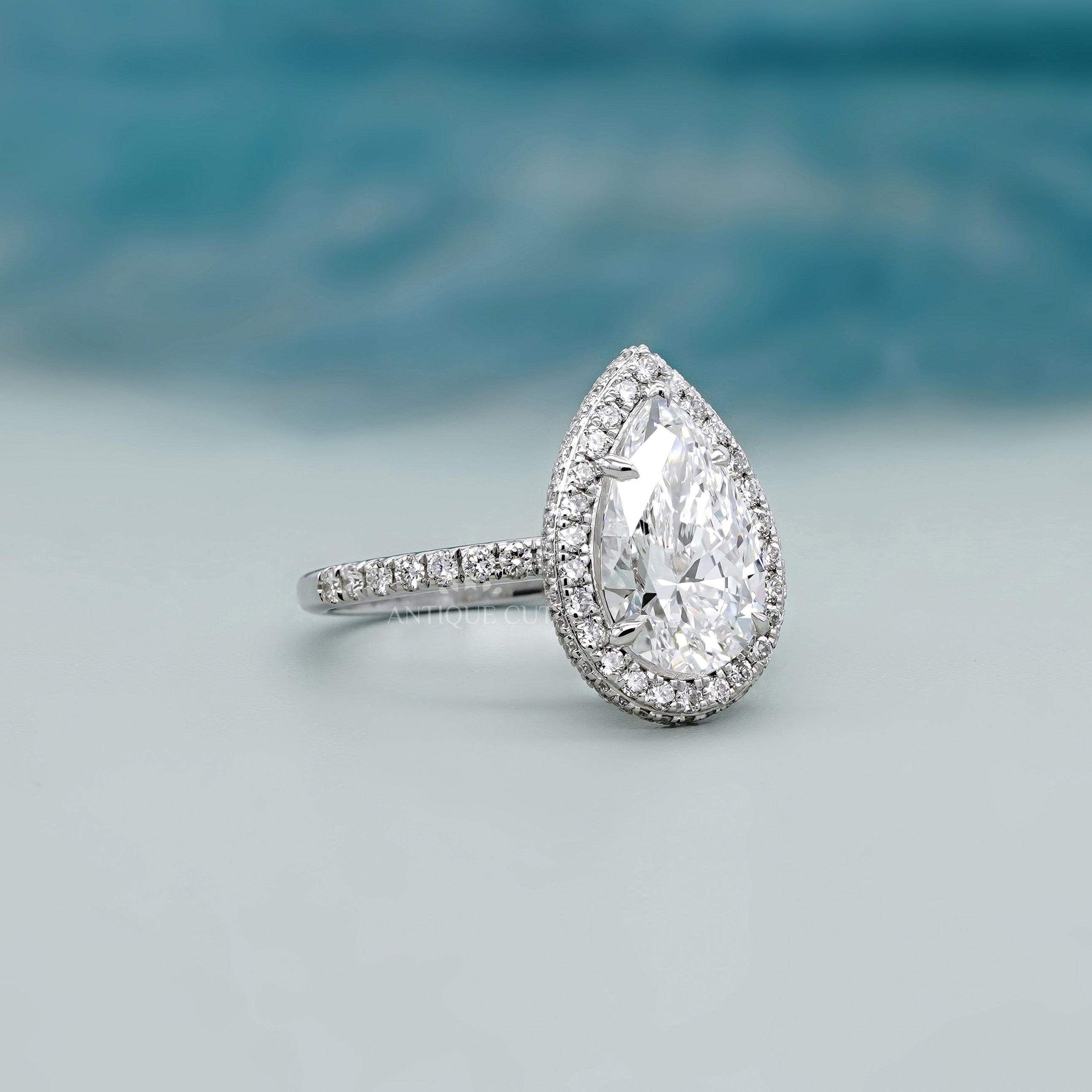 Antiquecut pear halo engagement ring white gold
