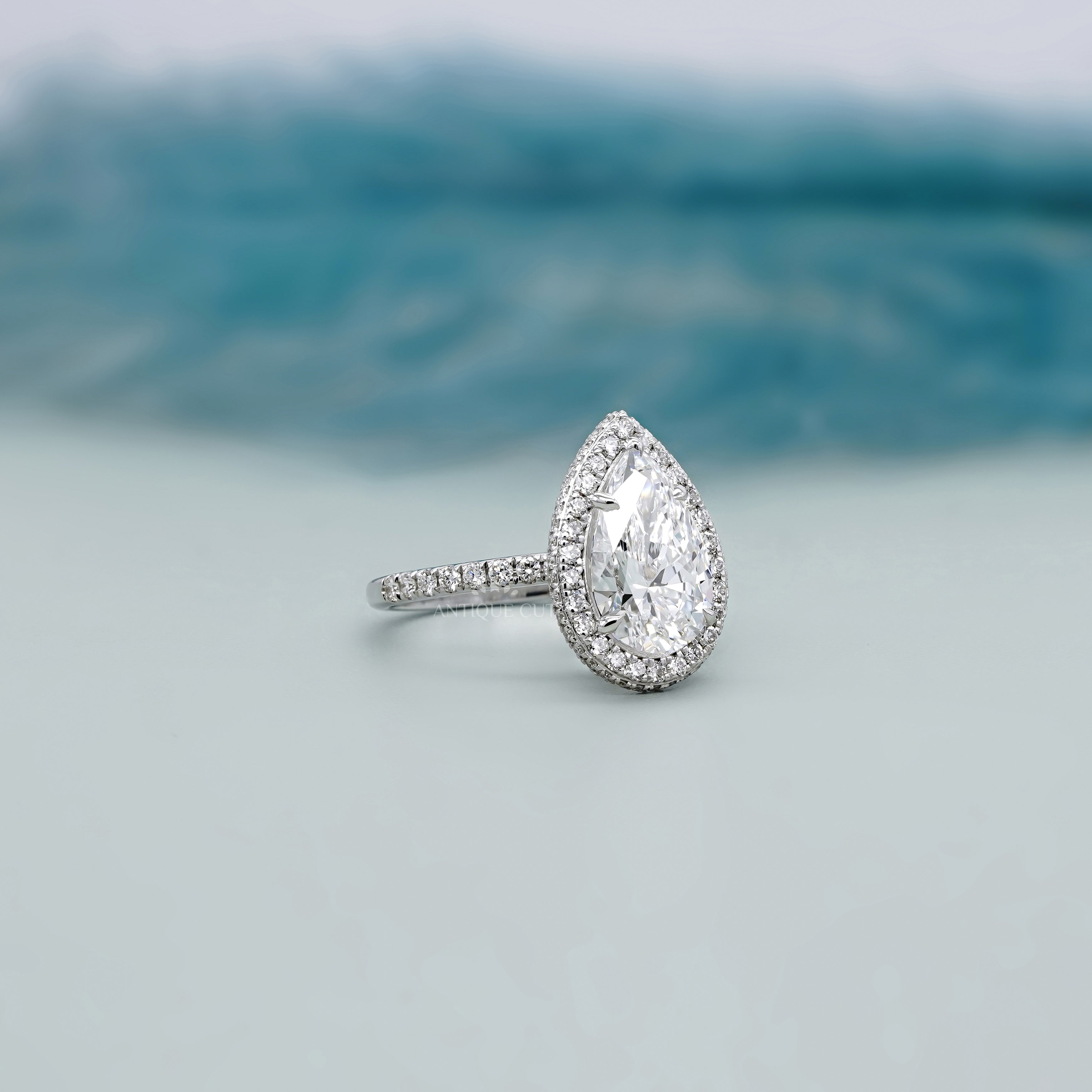 Antiquecut pear halo engagement ring white gold