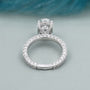 Hidden halo oval diamond engagement ring with sparkling pavé band
