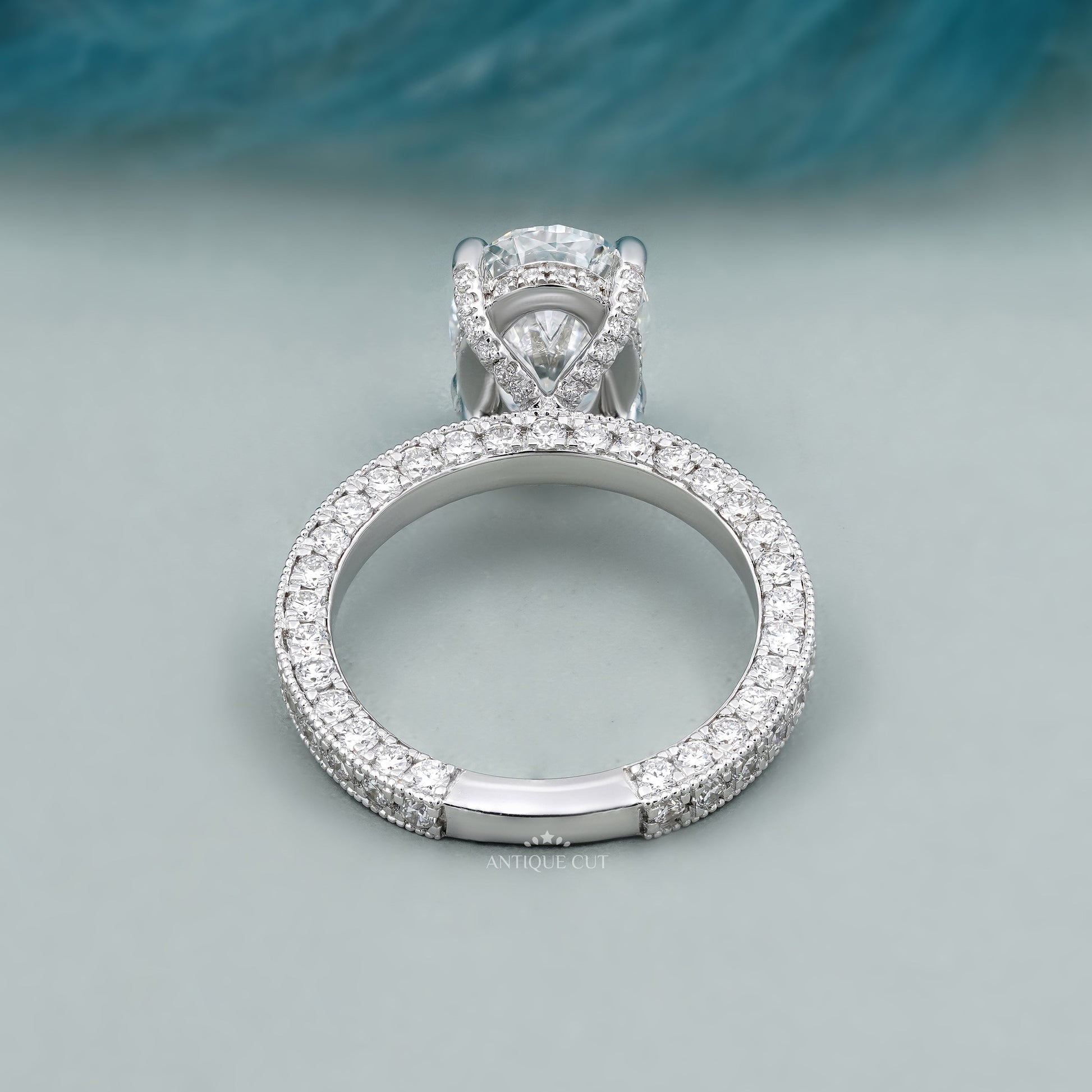 Hidden halo oval diamond engagement ring with sparkling pavé band