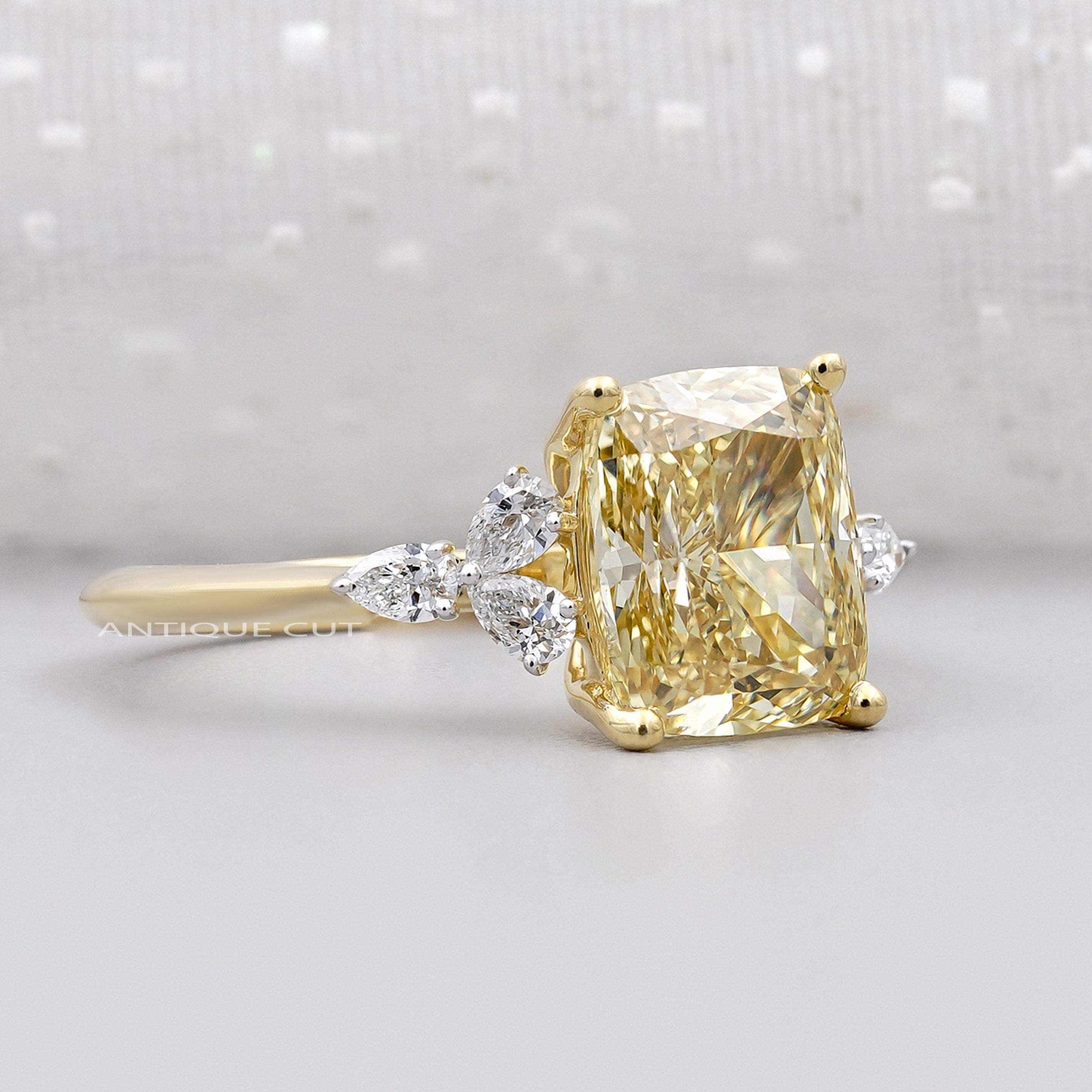 IGI certified yellow cushion cut diamond side stone ring
