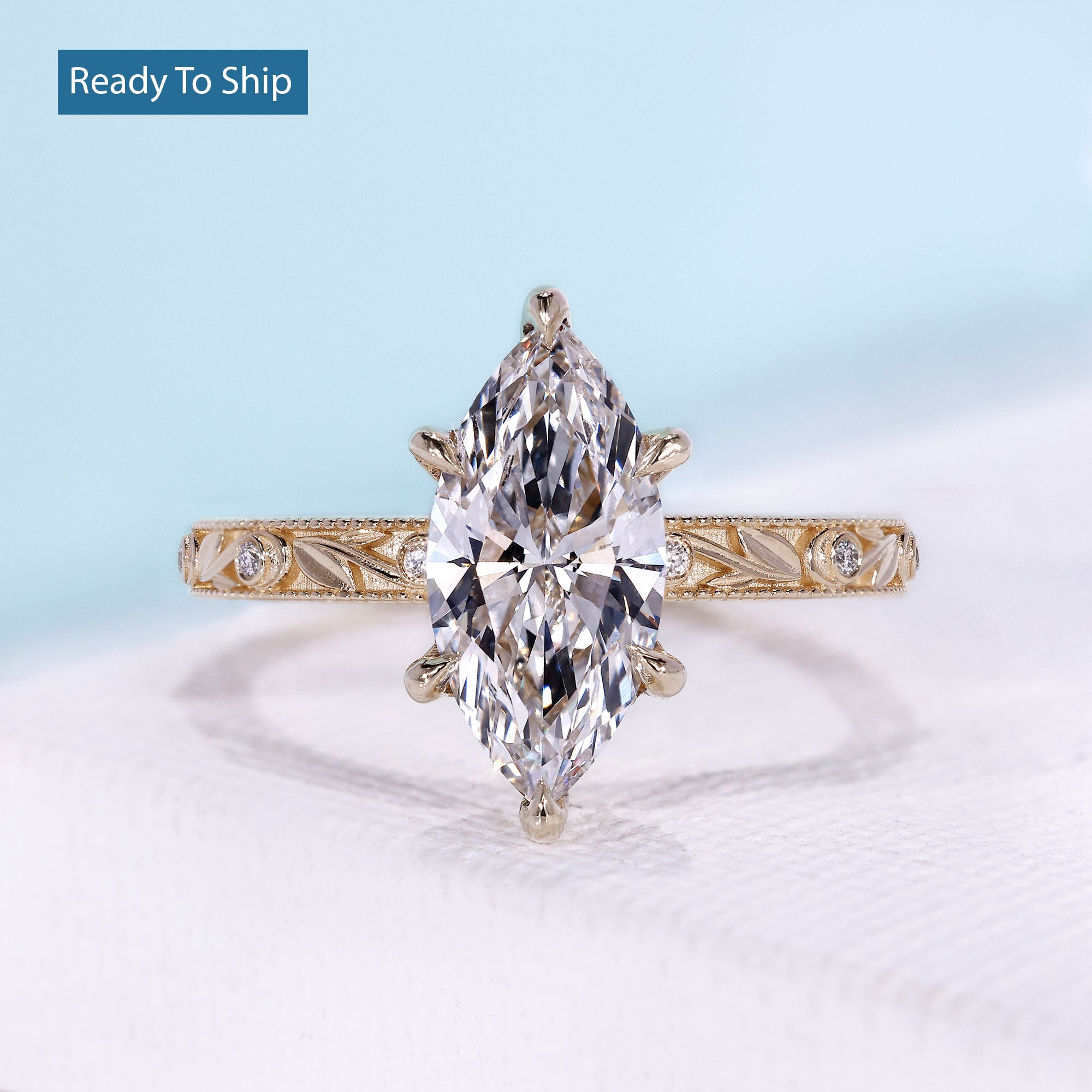 Vintage marquise engagement ring with hidden halo and yellow gold setting
