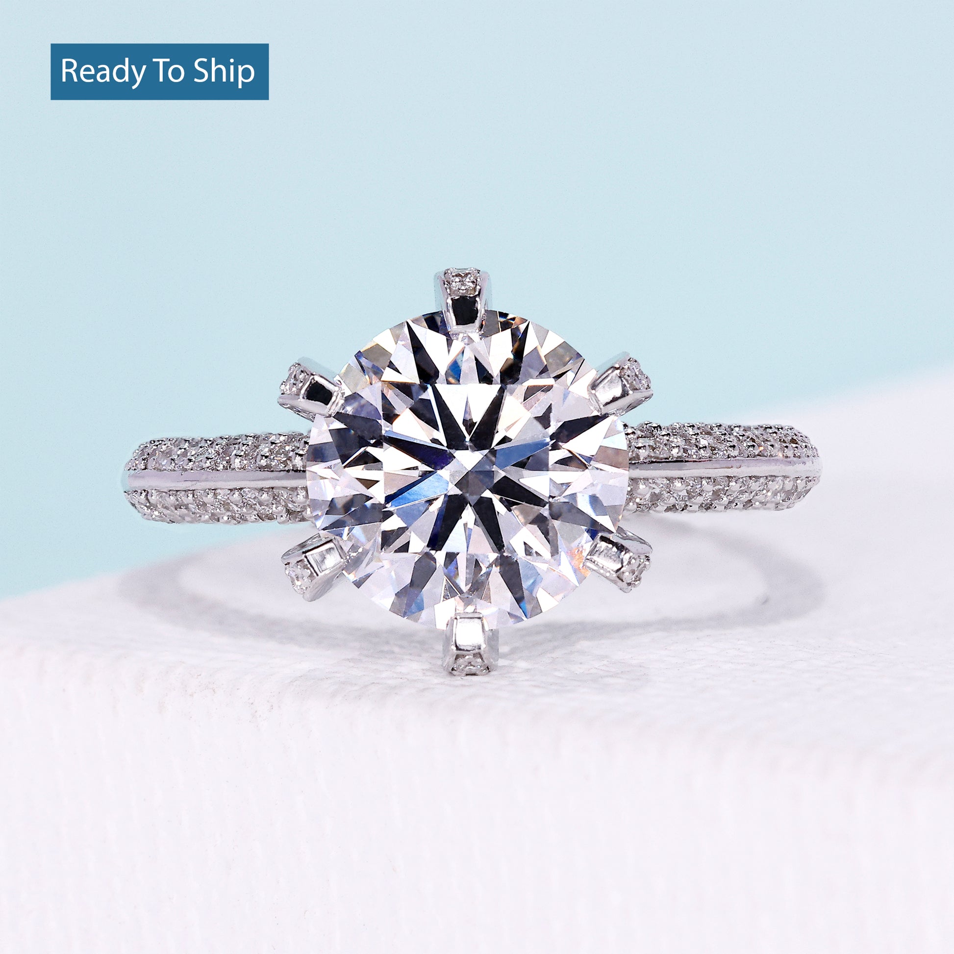 Round brilliant diamond ring with three row pave diamond band in white gold
