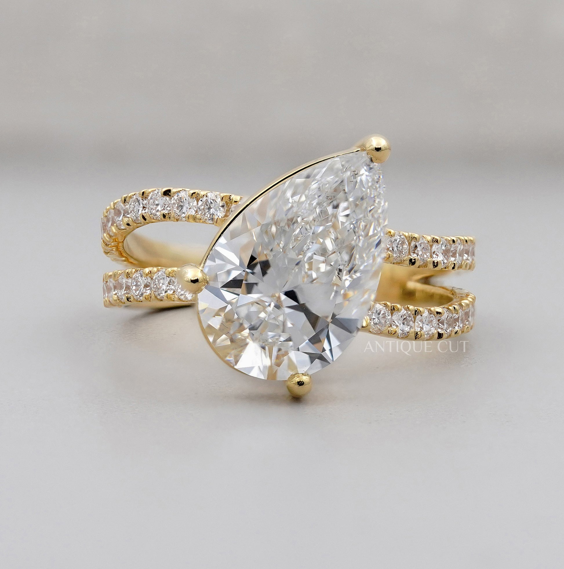 Pear cut lab grown diamond ring with pave split shank setting