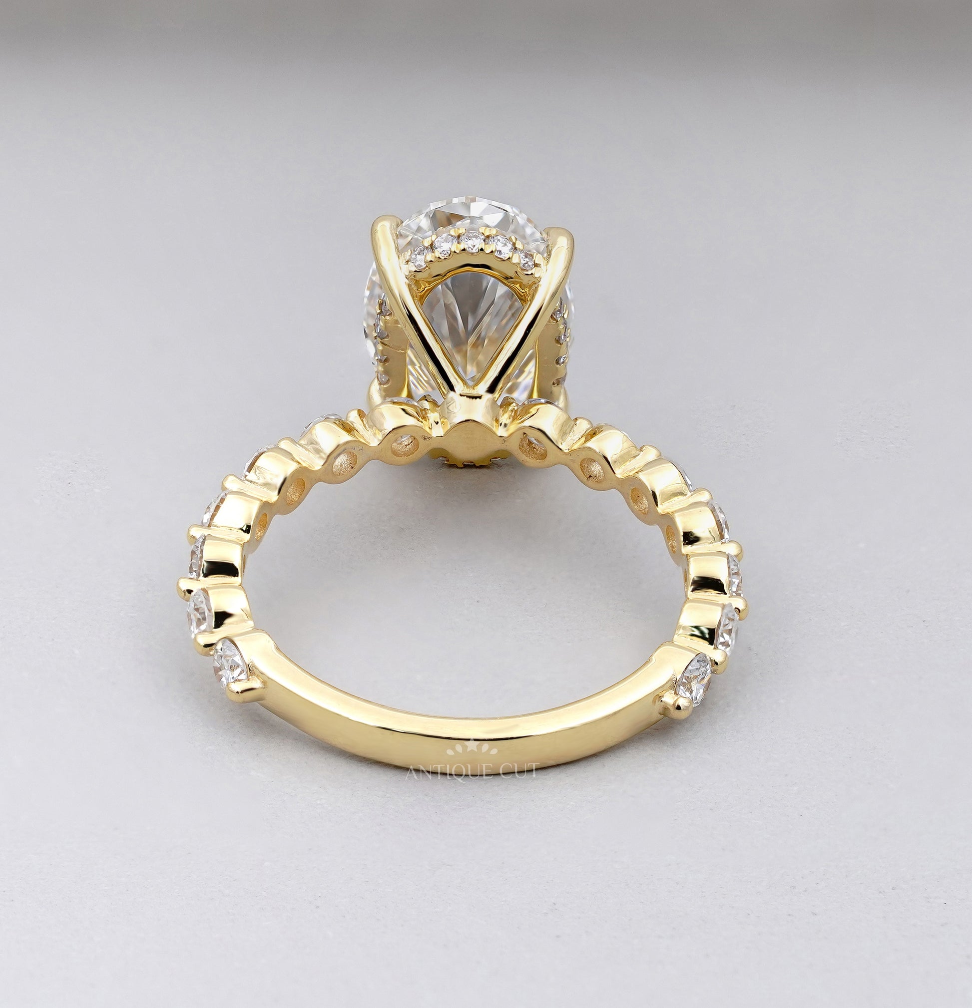 Oval center stone ring with shared-prong accent band