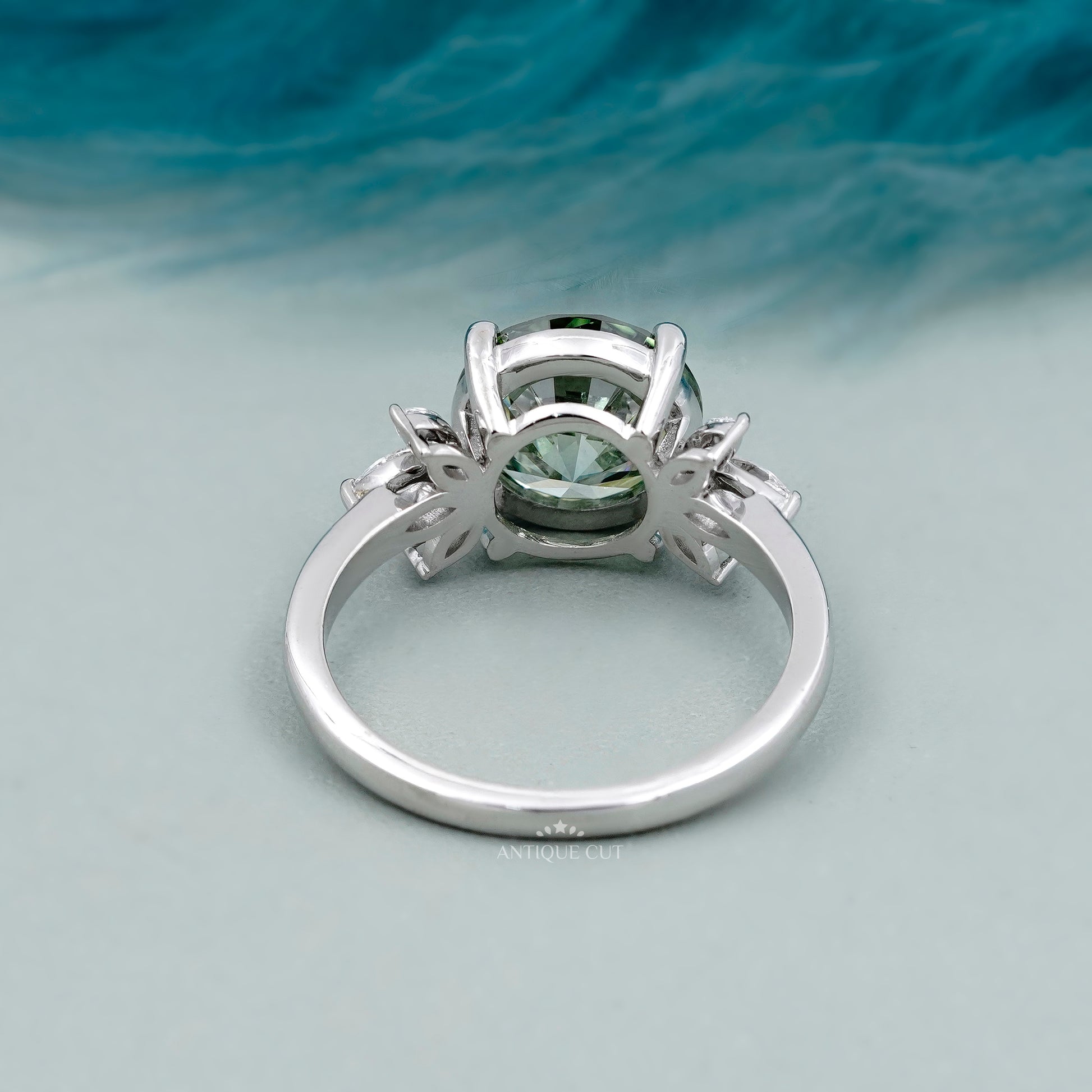 Round green diamond solitaire ring with marquise accents