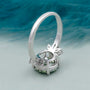 Elegant round cut green diamond ring with side stones