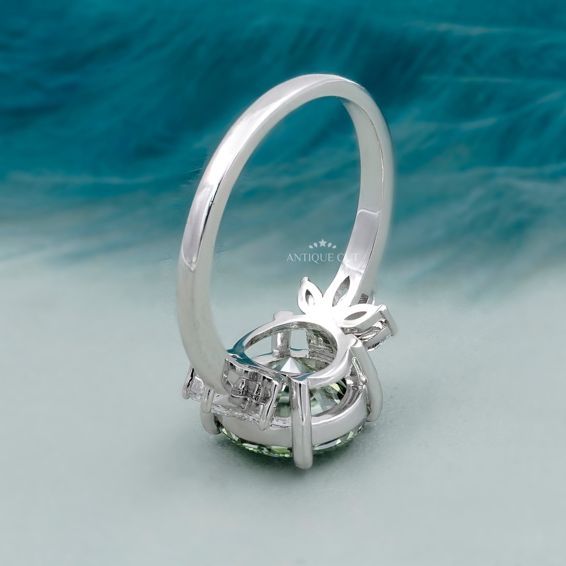 Elegant round cut green diamond ring with side stones