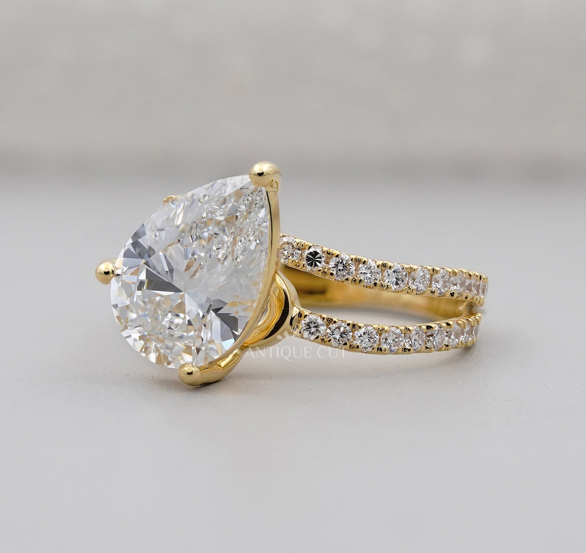 Pear shaped lab grown diamond ring with round side stones