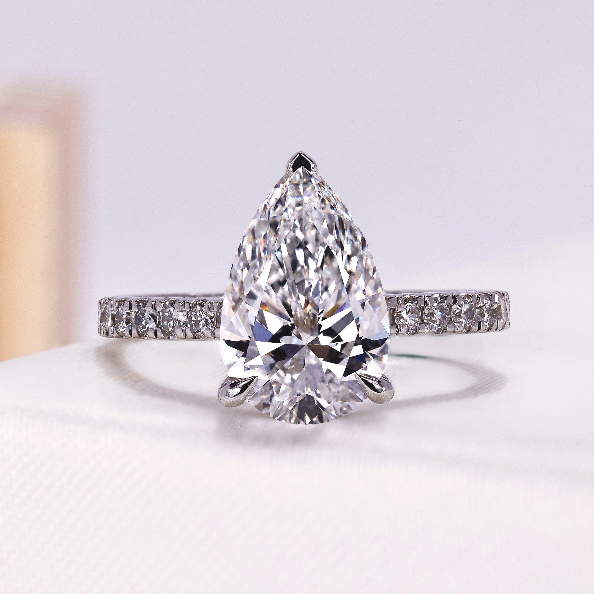 Pear lab grown diamond engagement ring with pavé band