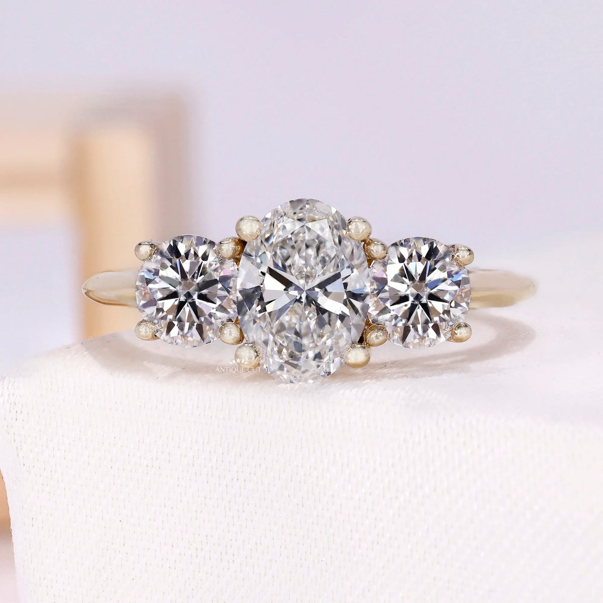 1.50 Carat Lab Grown Oval Cut Center Diamond & Two Round Side Stones With Trellis Gallery Setting