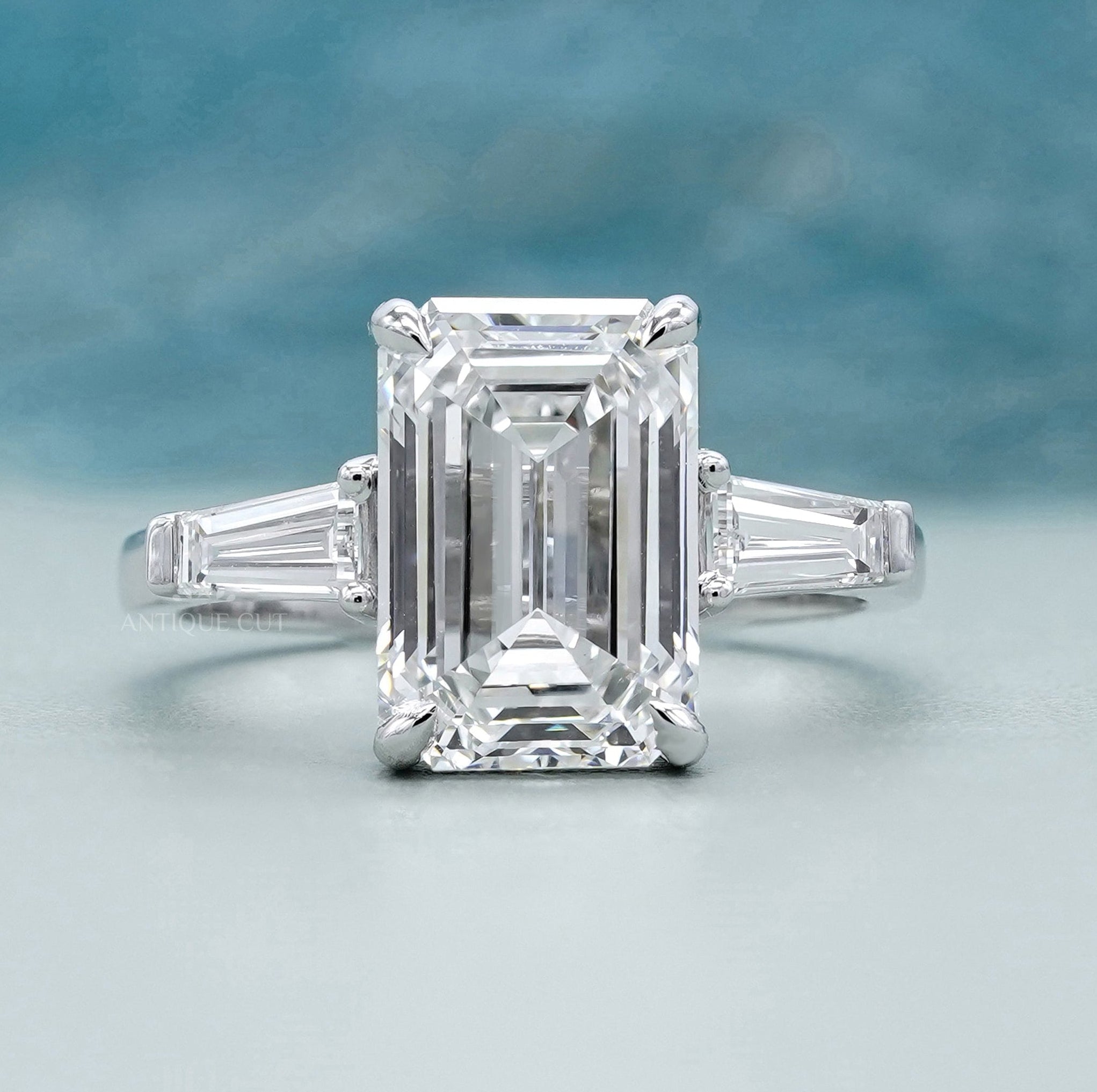 Emerald three stone engagement ring in white gold
