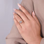 Detailed view of round side stones beside the cushion center diamond