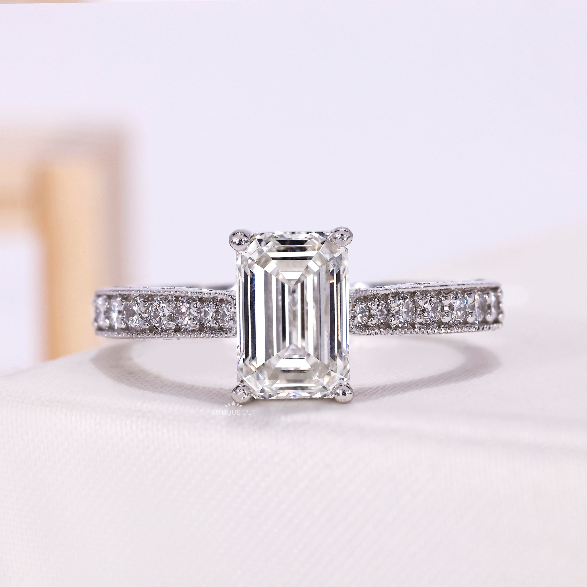 Vintage emerald cut diamond engagement ring with pavé band