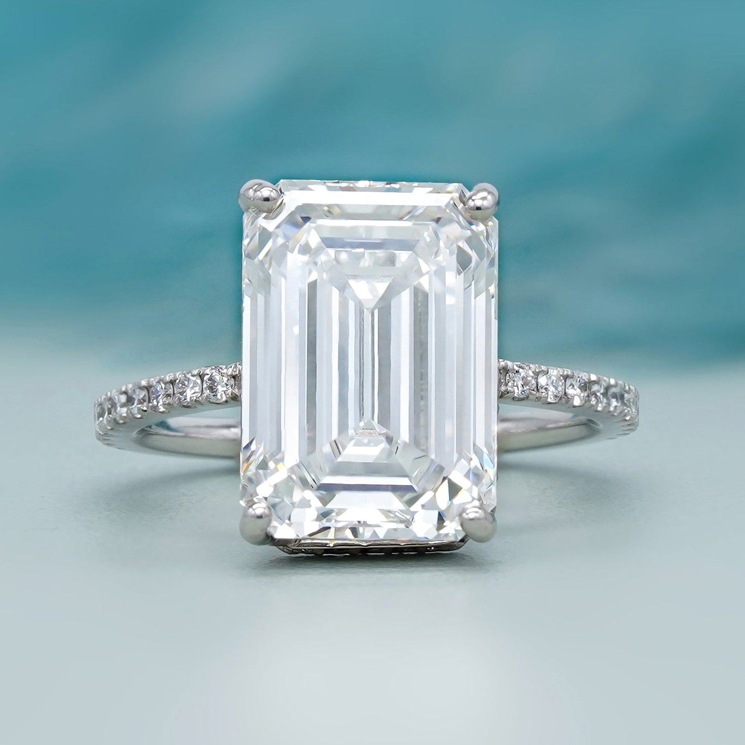 hidden halo emerald cut engagement ring in white gold
