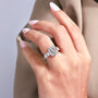 Three-quarter view of radiant ring with emerald cut side stones