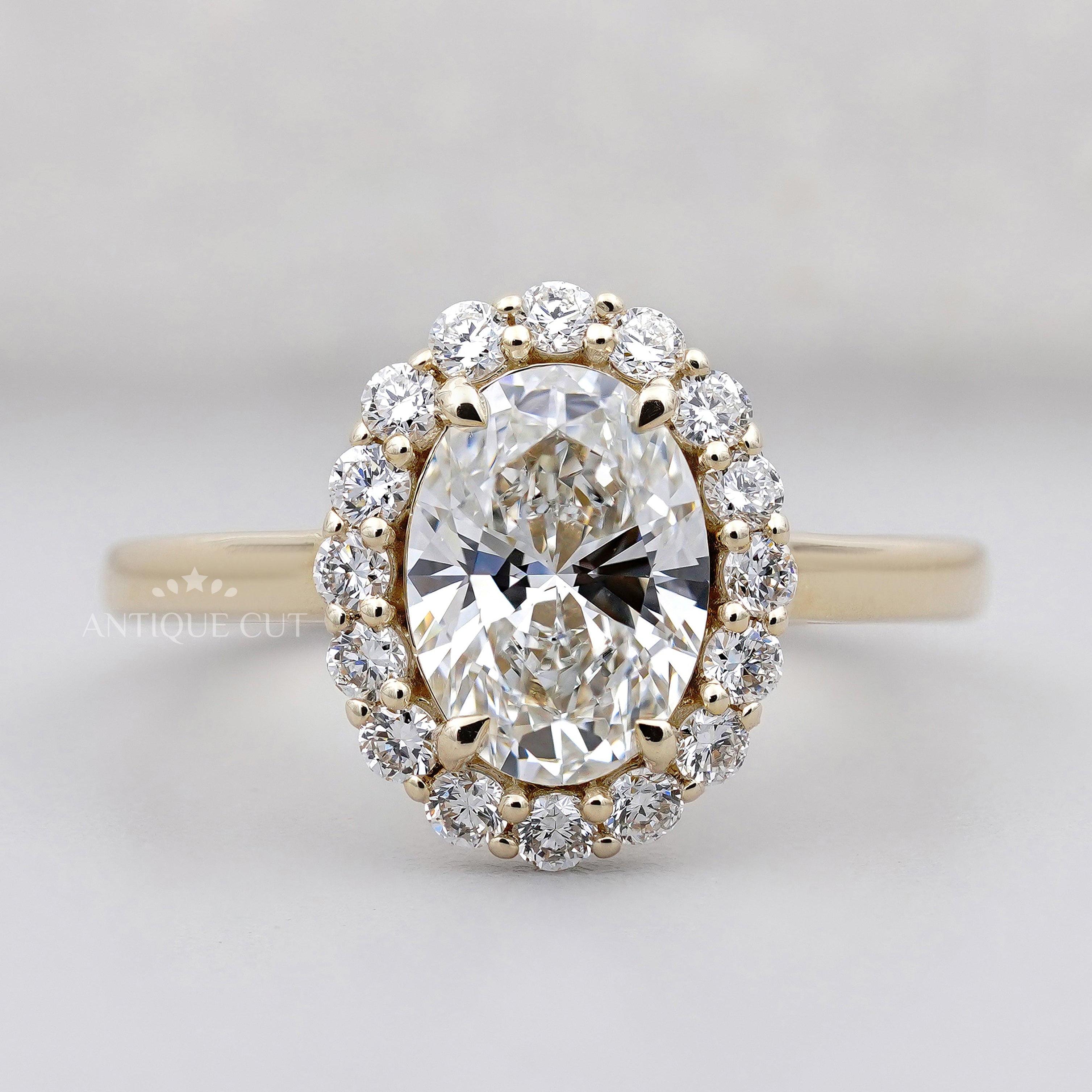 Oval halo diamond engagement ring in 14k yellow gold