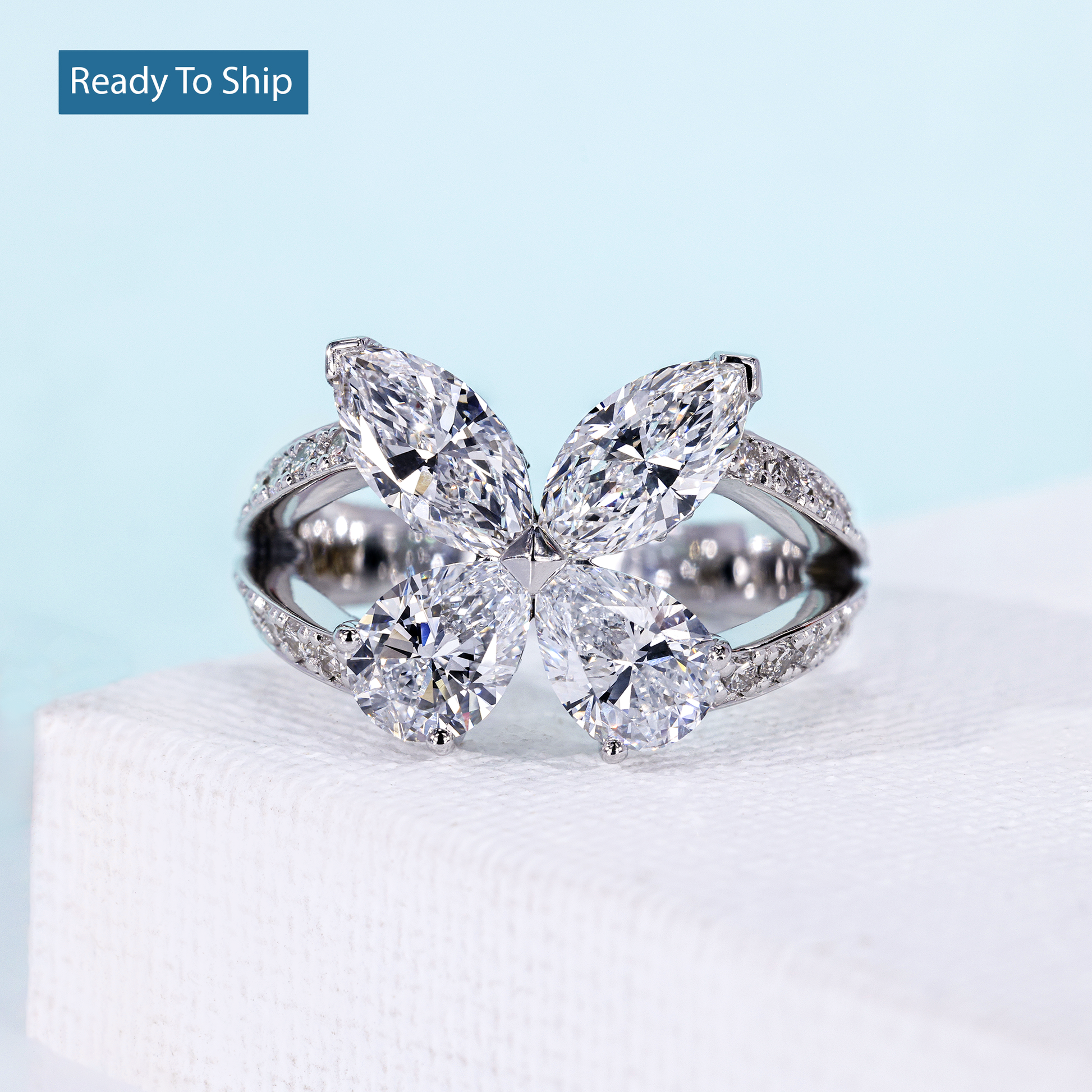 Butterfly engagement ring with pear and marquise cut diamonds