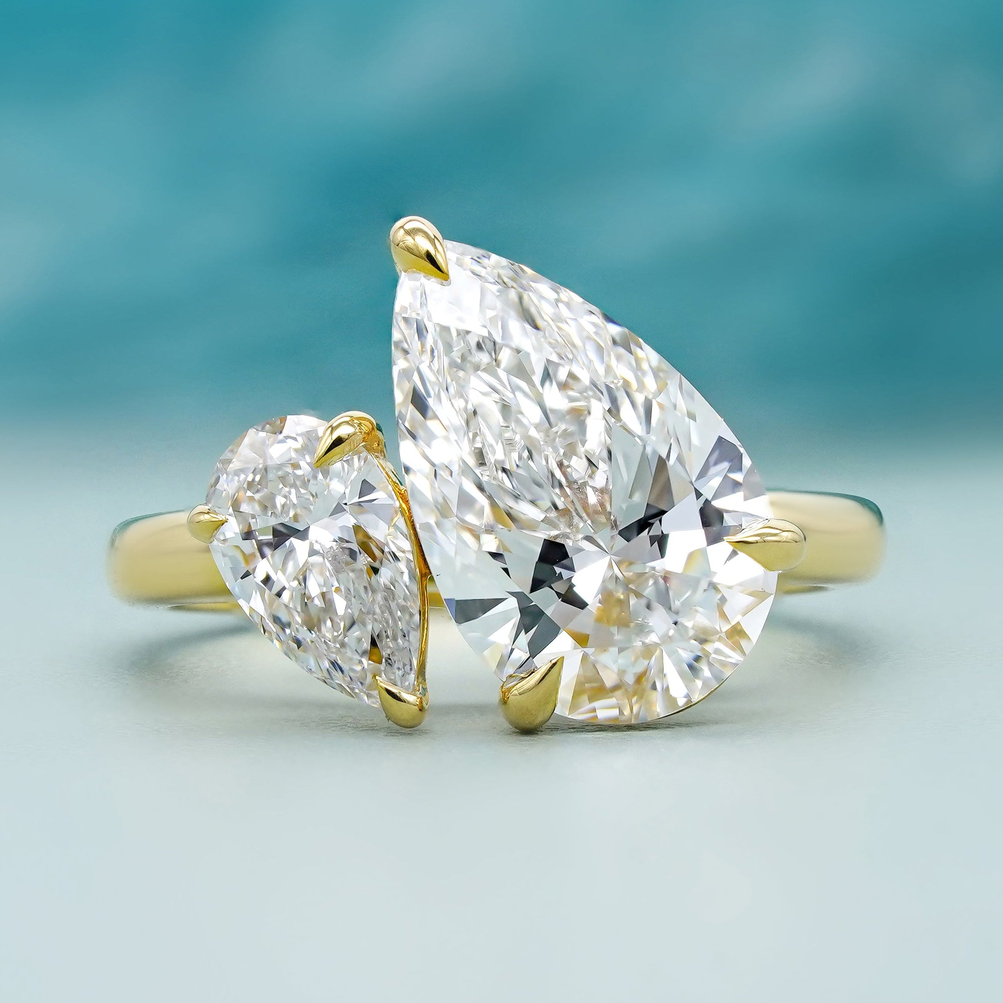 Double pear engagement ring in yellow gold