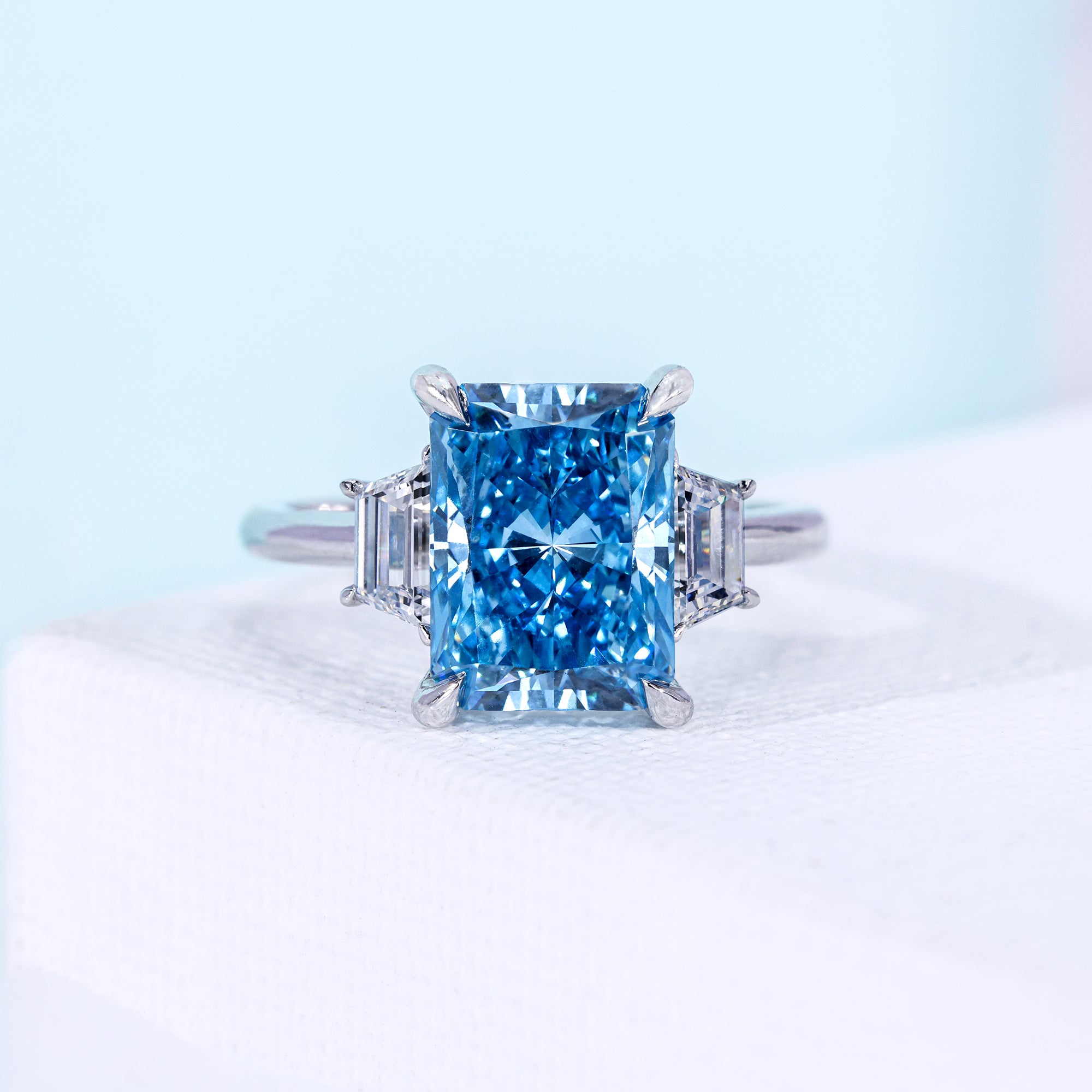 Fancy Blue Radiant Cut Three Stone Lab Grown Diamond Engagement Ring with Tapered Baguette Side Stones