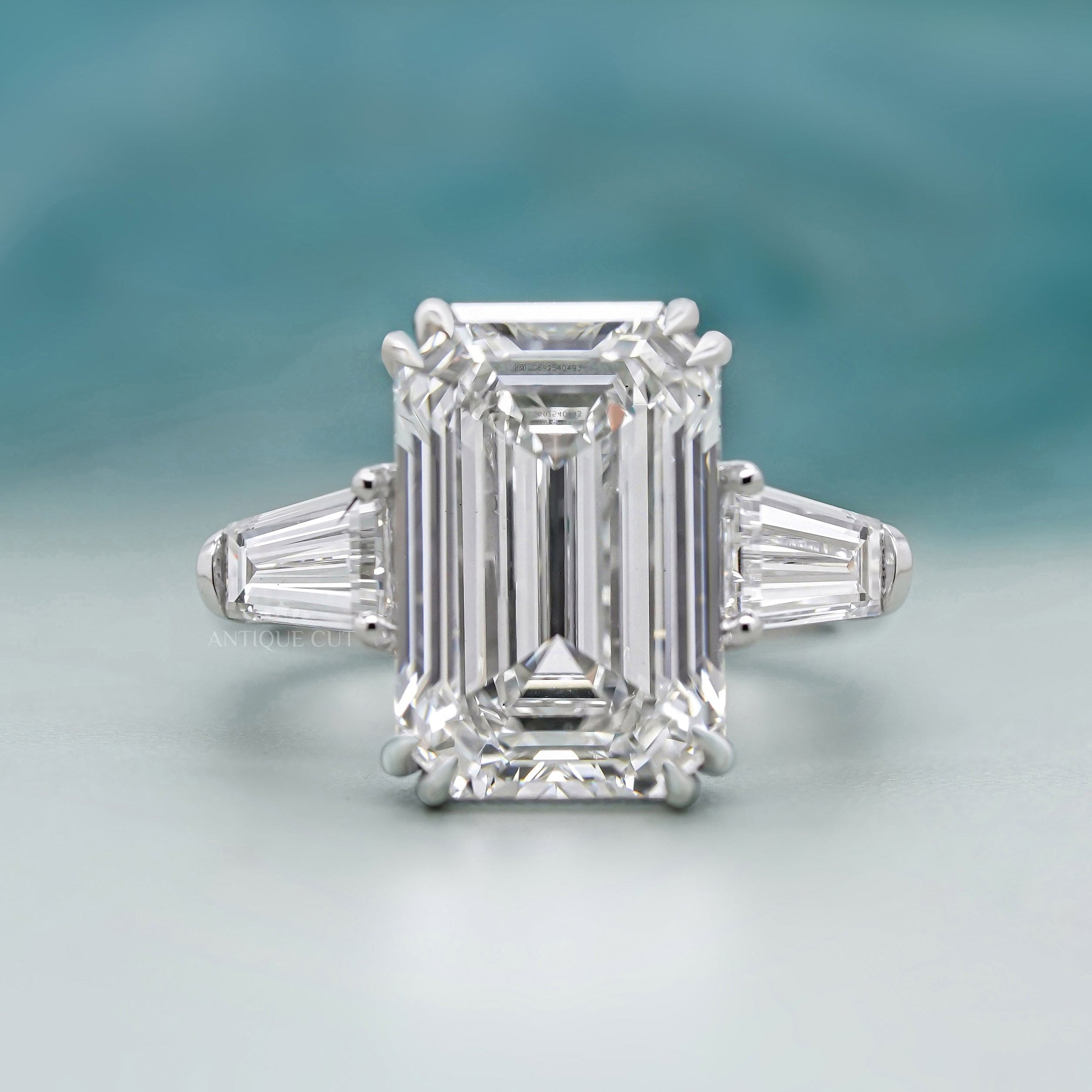 Emerald cut diamond ring with baguette tapered side stones white gold