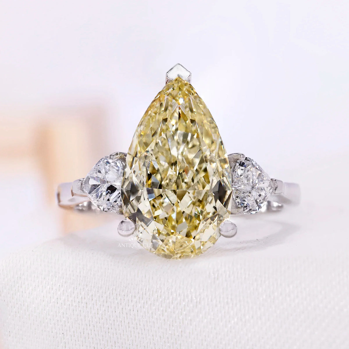 Yellow pear lab grown diamond ring with three stone setting