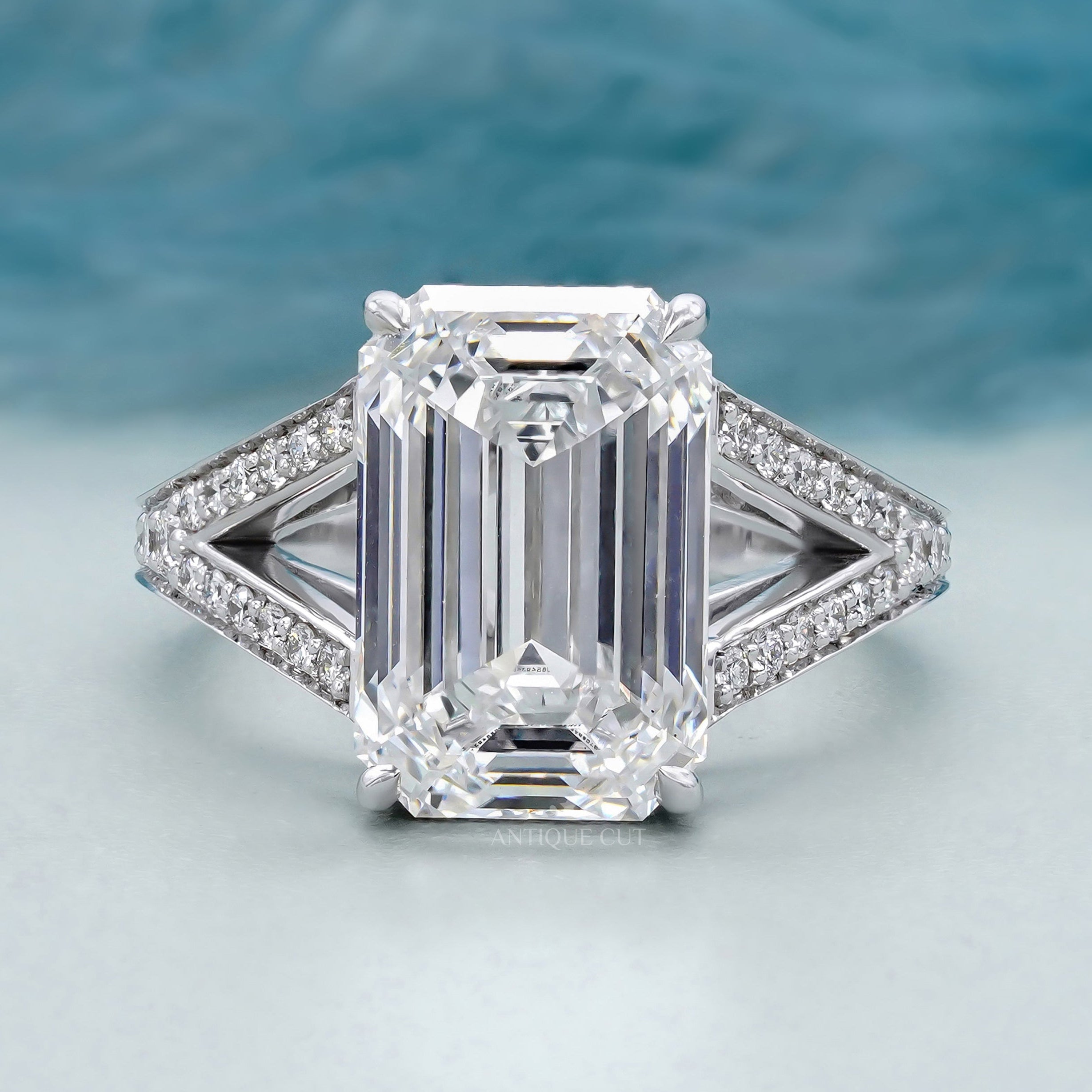 Emerald cut diamond split shank engagement ring in white gold