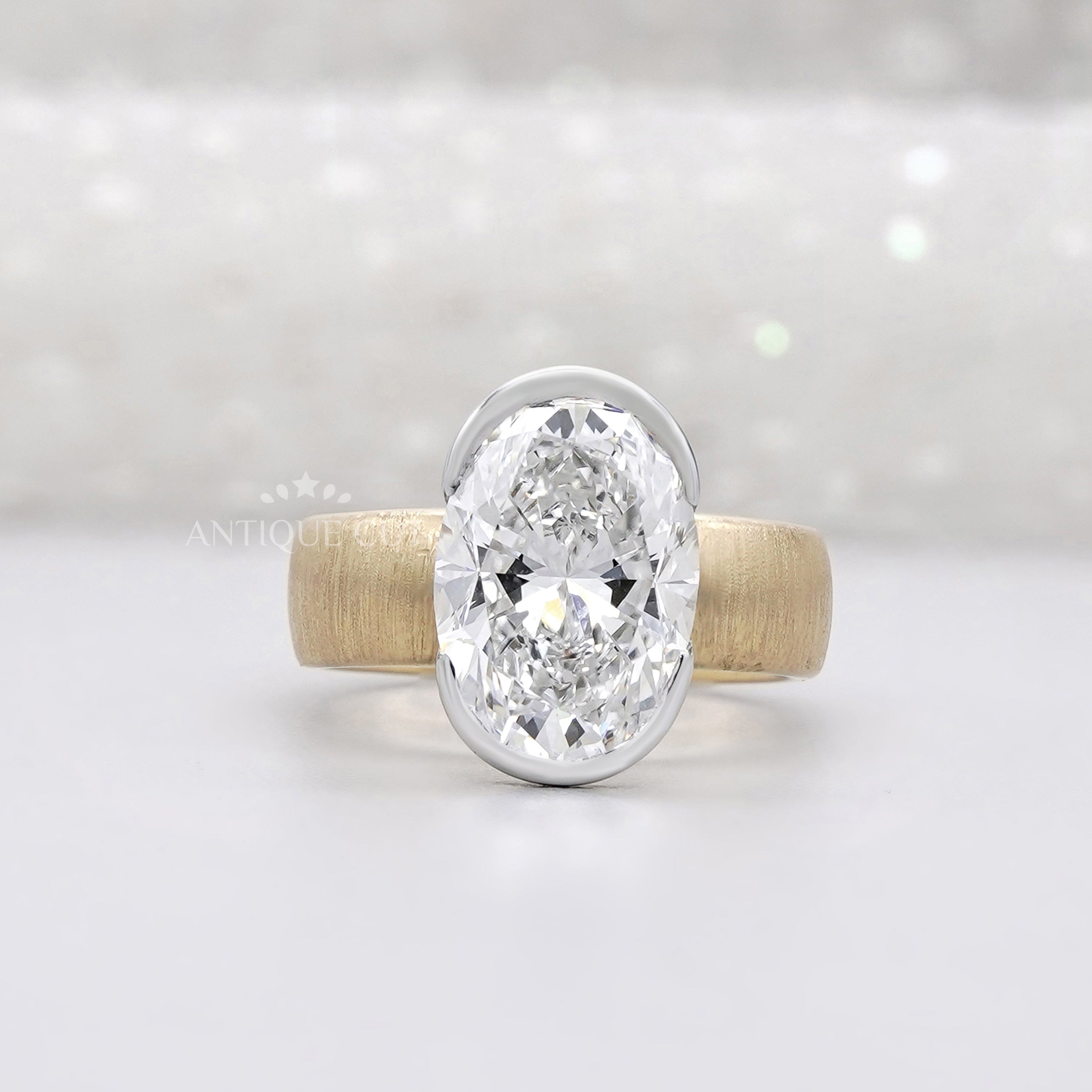 Oval bezel set engagement ring with solitaire diamond