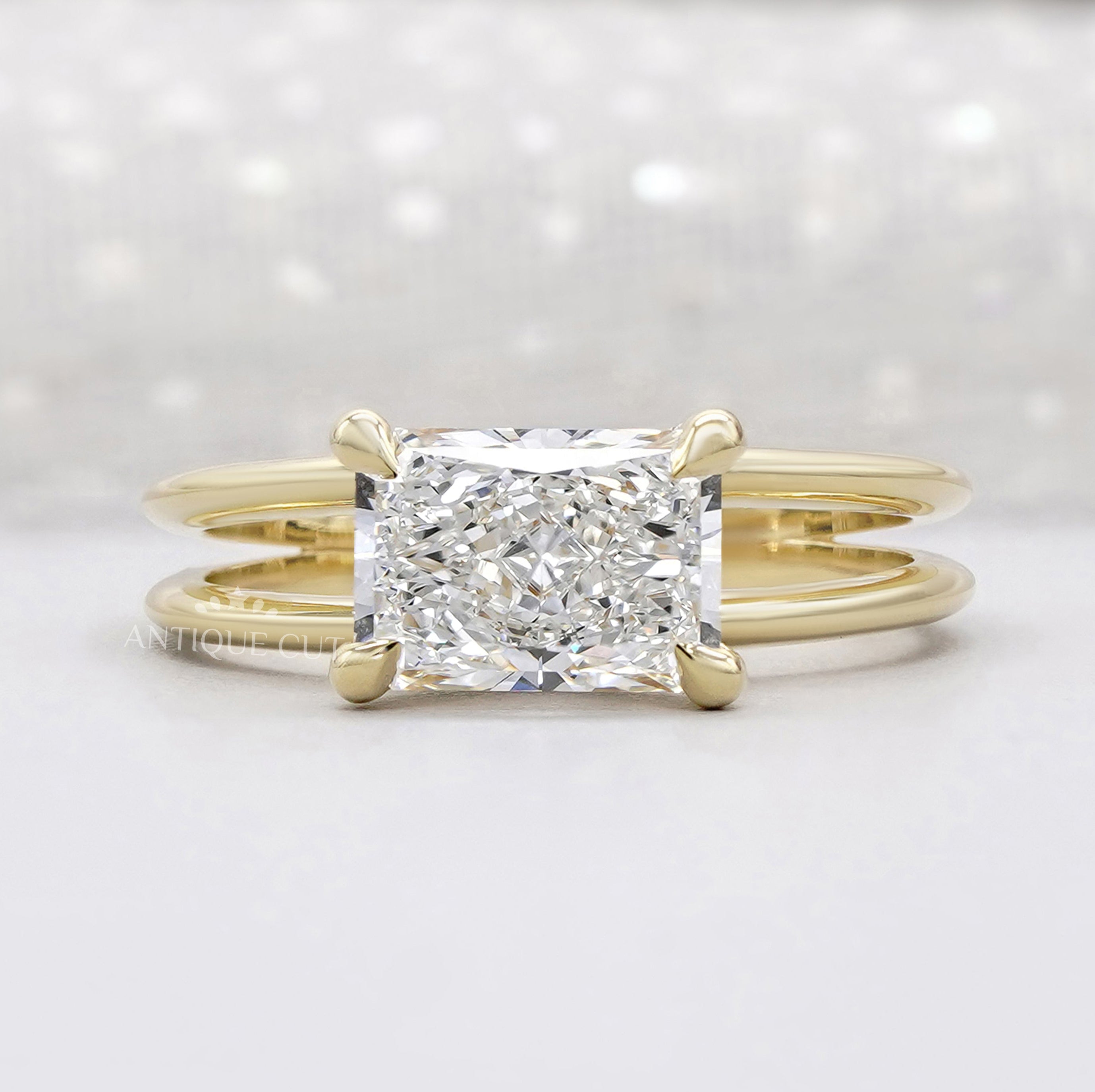 East west radiant cut engagement ring in yellow gold