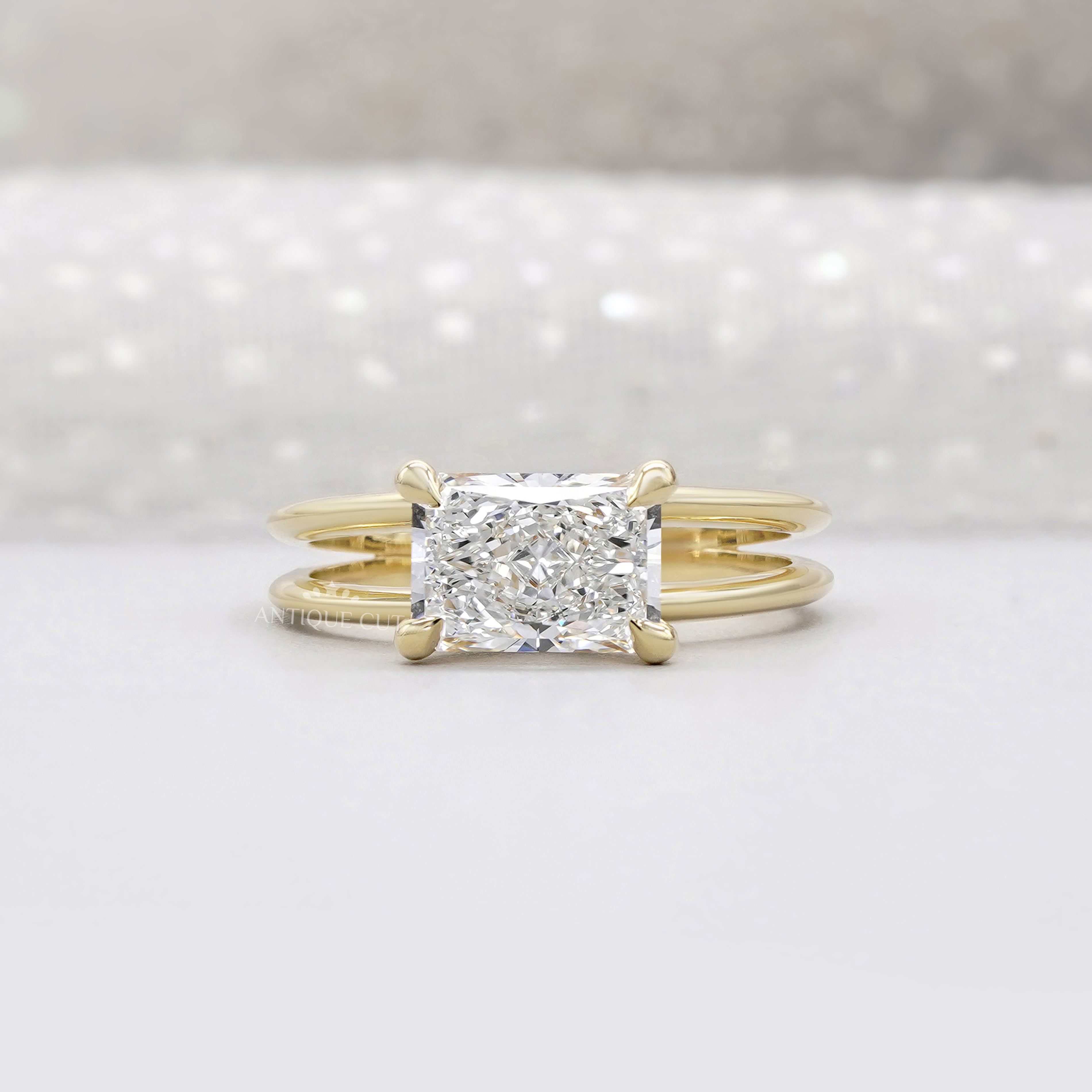East west radiant cut engagement ring in yellow gold