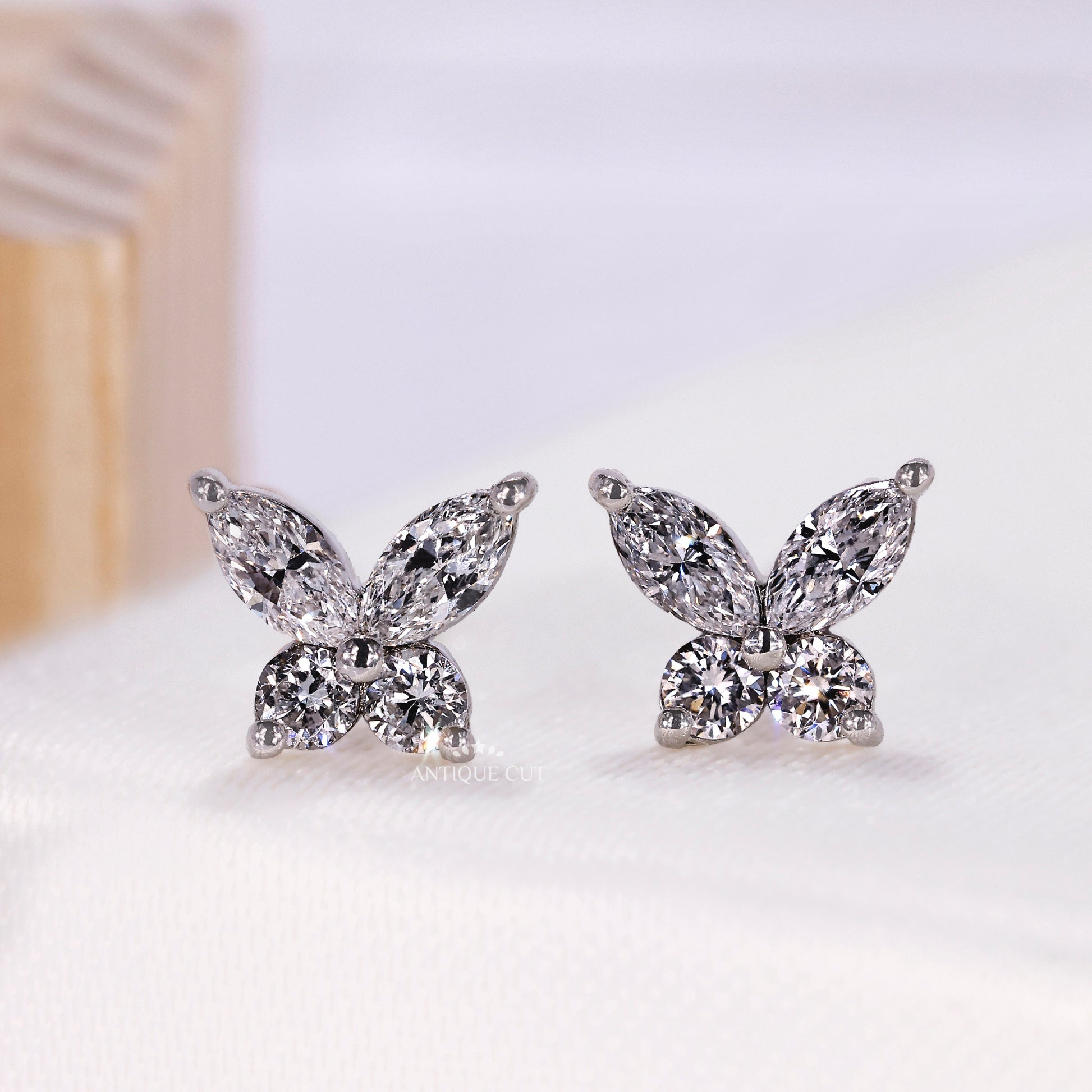 White gold butterfly stud earring with marquise and pear diamonds
