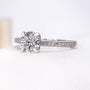Antiquecut white gold ring with round center diamond and pavé band